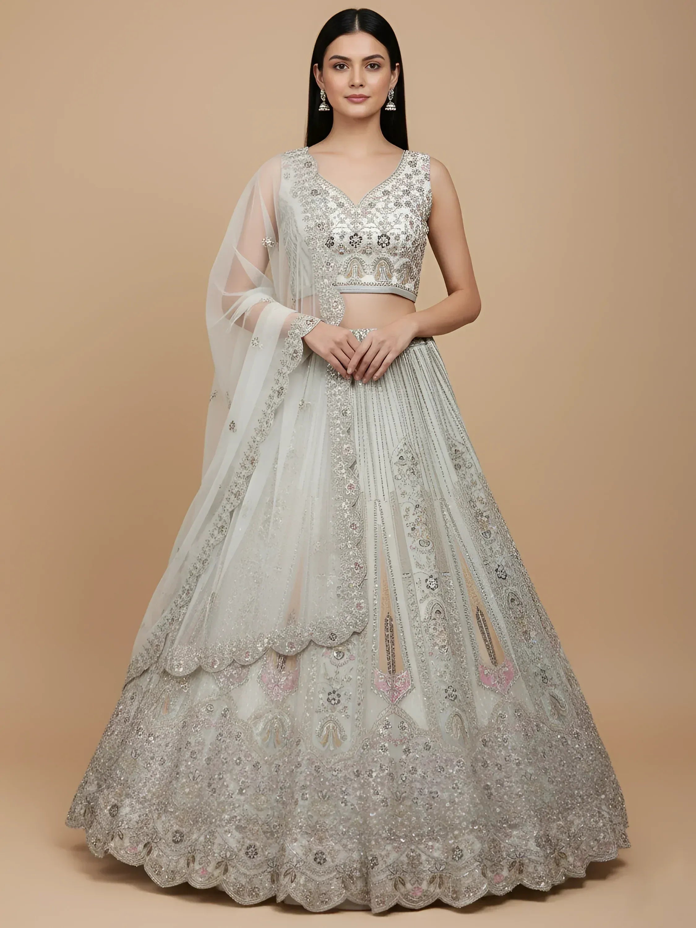 Elegant silver lehenga choli with heavy embroidery and sheer dupatta, perfect for Indian weddings and festive occasions.