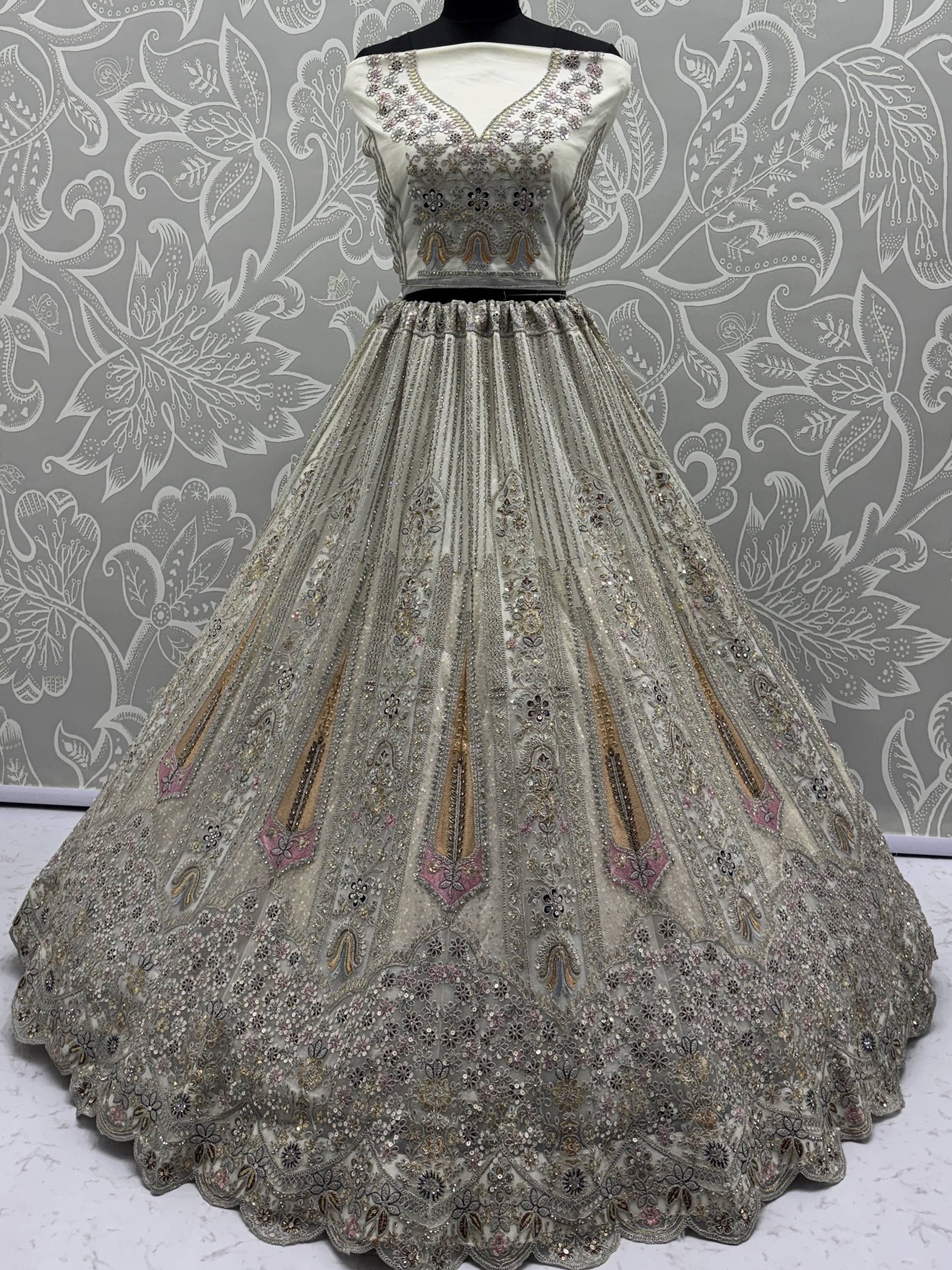 Elegant silver embroidered lehenga choli with floral motifs and sequin detailing, perfect for Indian ethnic occasions.