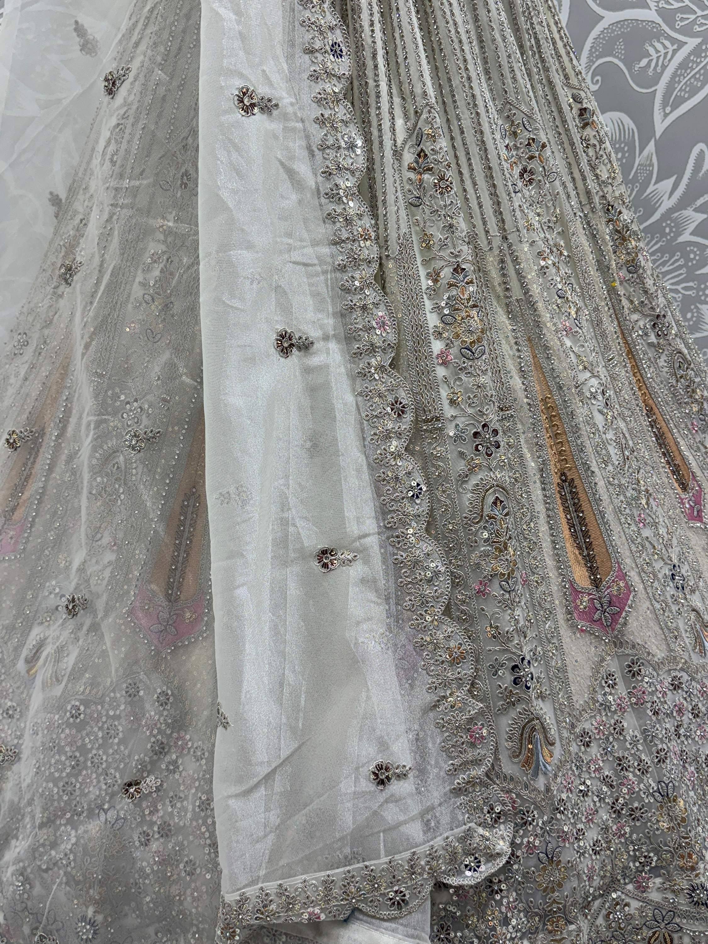 Elegant white lehenga choli with intricate floral embroidery and sequin detailing, perfect for Indian ethnic wear.