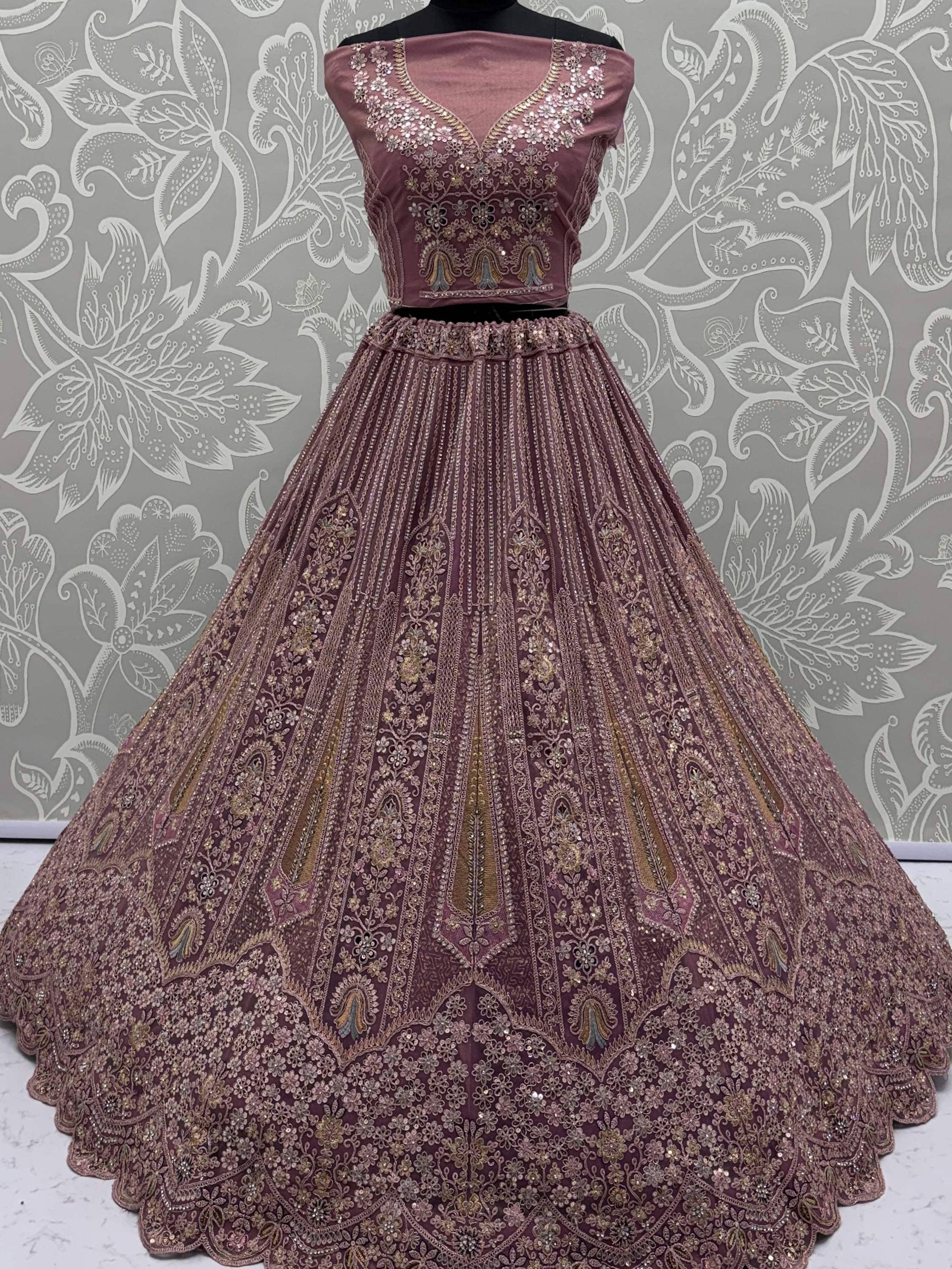 Dusty rose designer lehenga choli with intricate gold embroidery and sequin work, perfect for Indian weddings