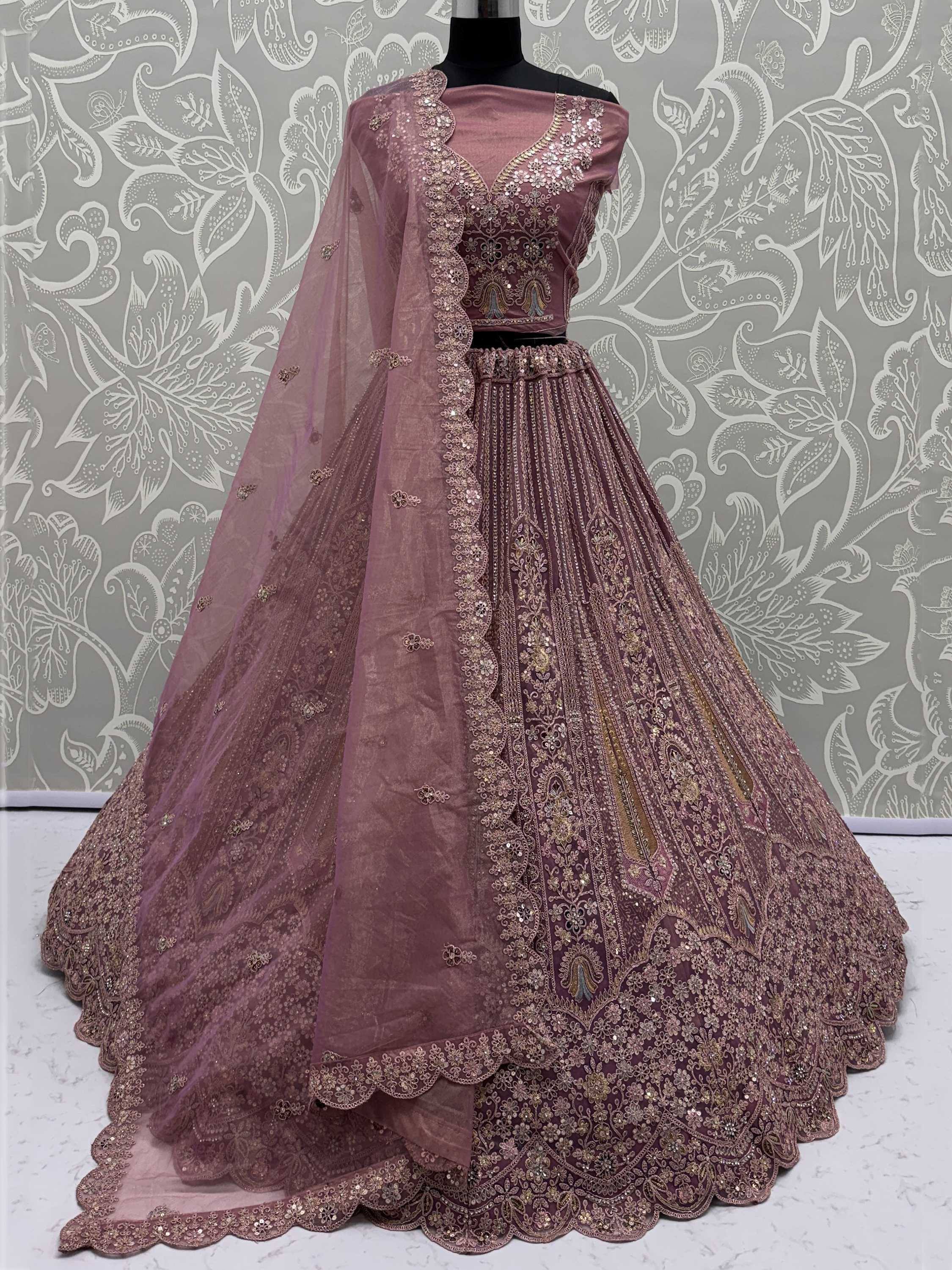 Dusty rose designer lehenga choli with heavy gold embroidery and net dupatta, perfect for weddings