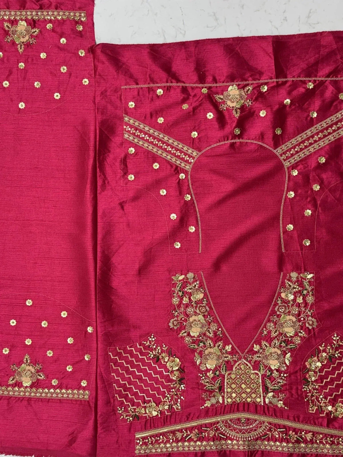 Pink embroidered lehenga choli with gold floral motifs and detailed neckline design