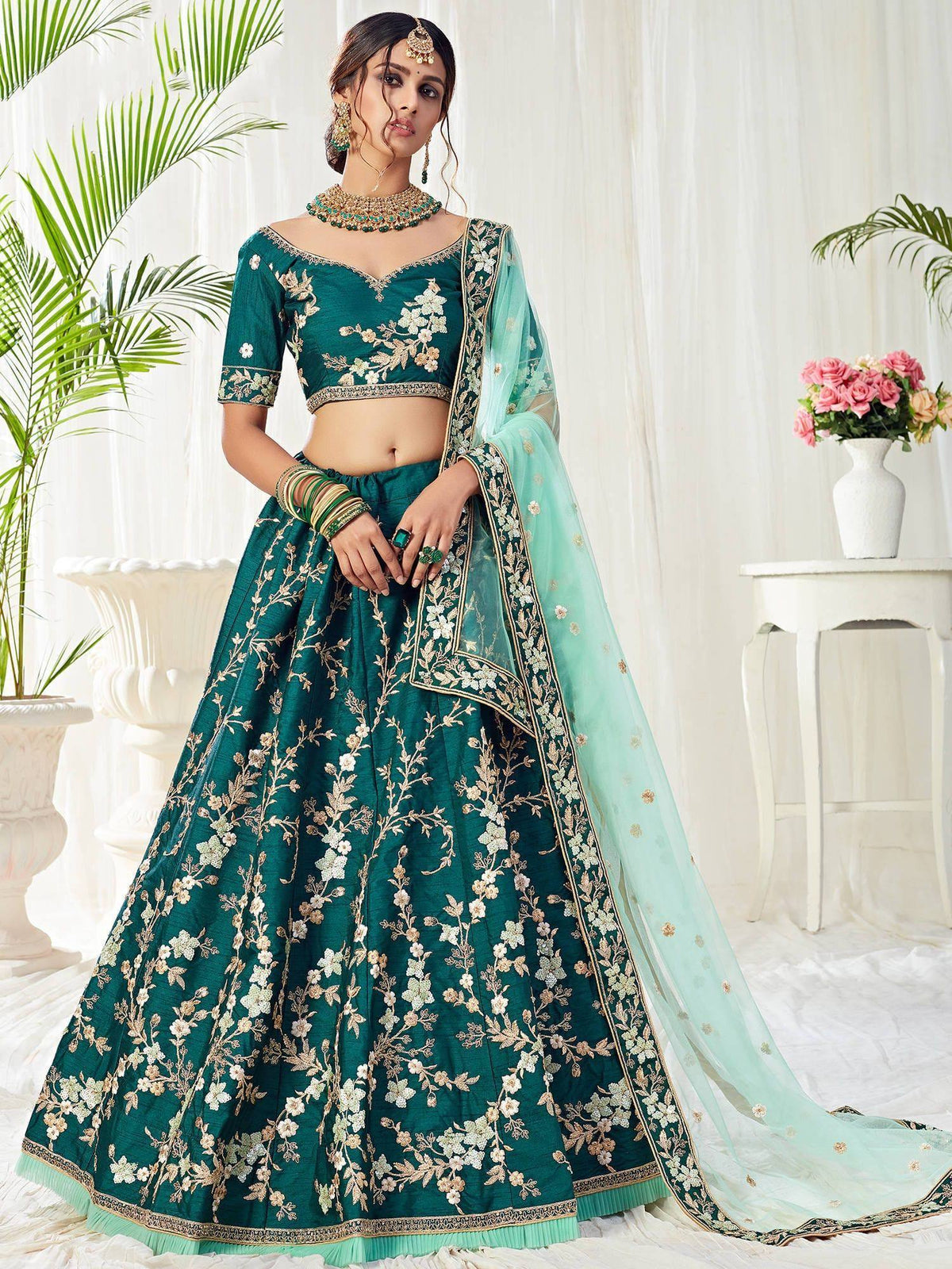 Emerald green embroidered lehenga choli with floral motifs and sheer dupatta for Indian weddings