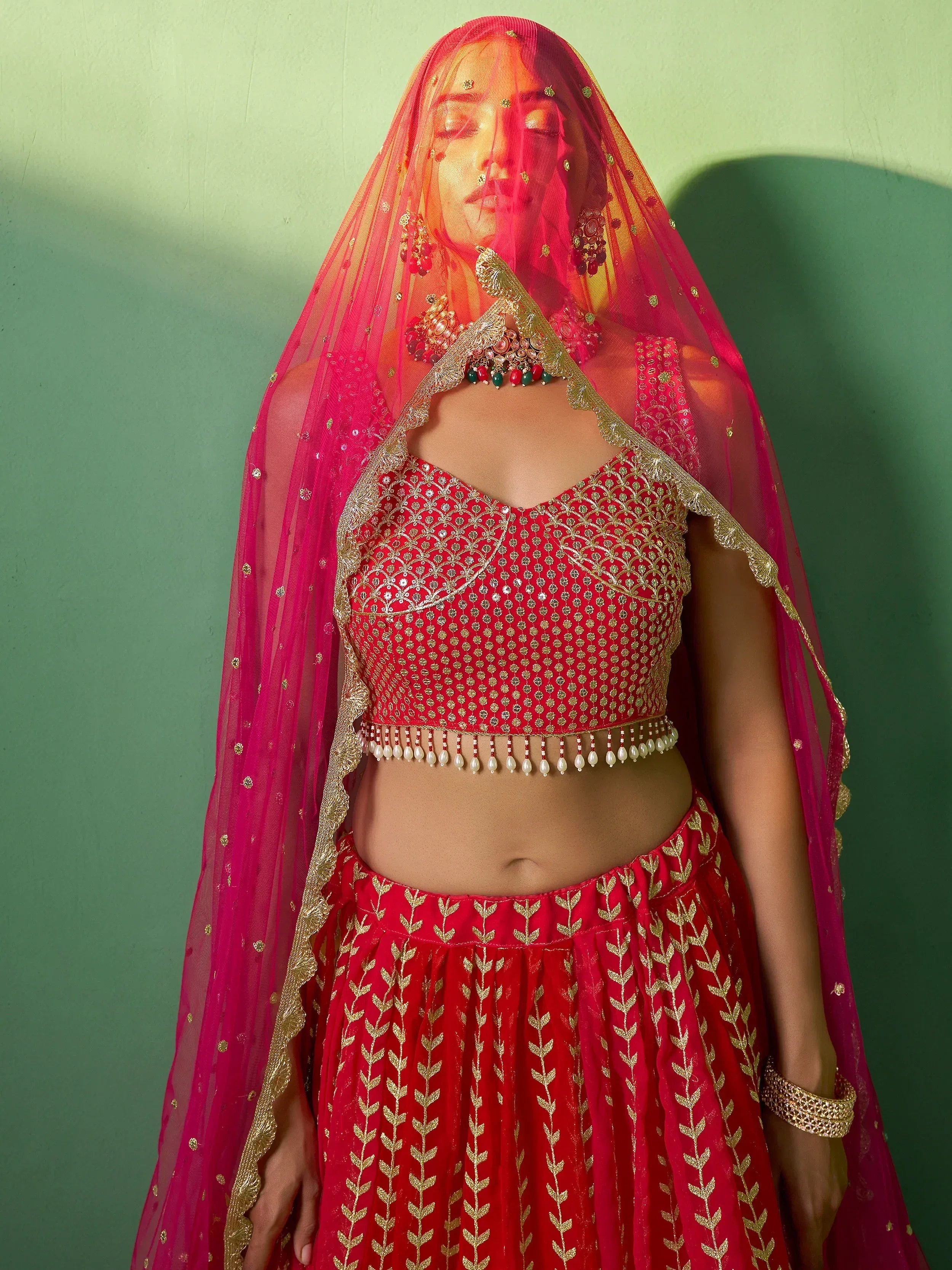Red embroidered lehenga choli with gold detailing and matching dupatta for Indian ethnic wear