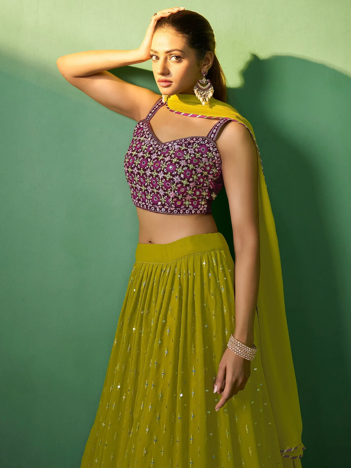 Elegant purple embroidered blouse with green lehenga and dupatta, perfect for Indian ethnic wear.