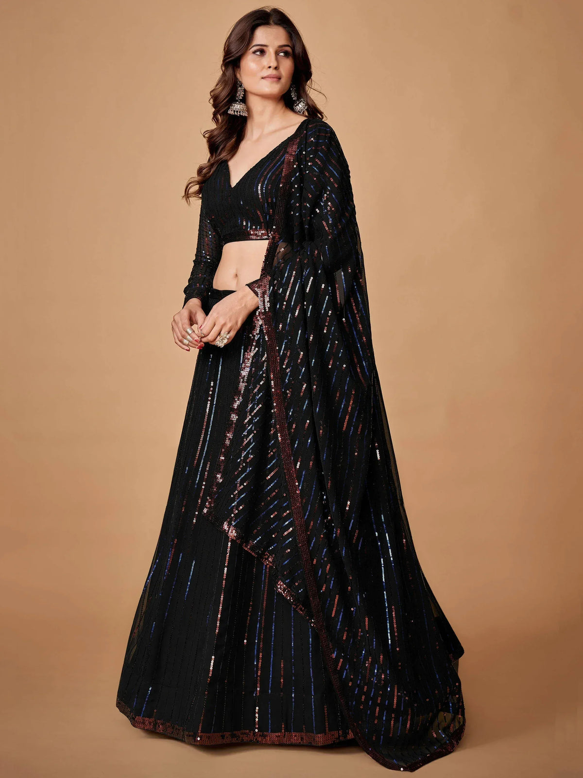 Black sequin lehenga choli with shimmering stripes and elegant drape for festive occasions