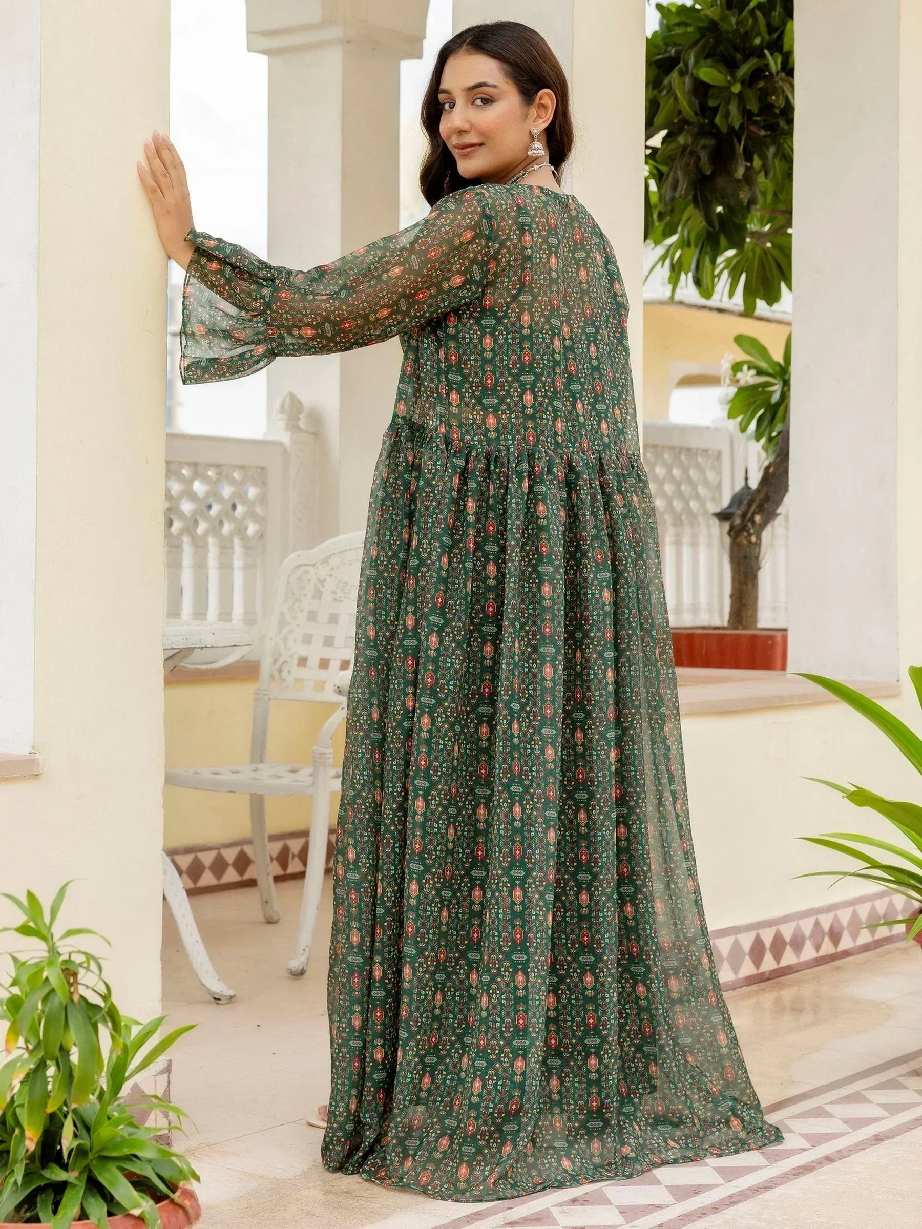 Green printed ethnic gown with flared sleeves, perfect for Indian occasions and festive wear.