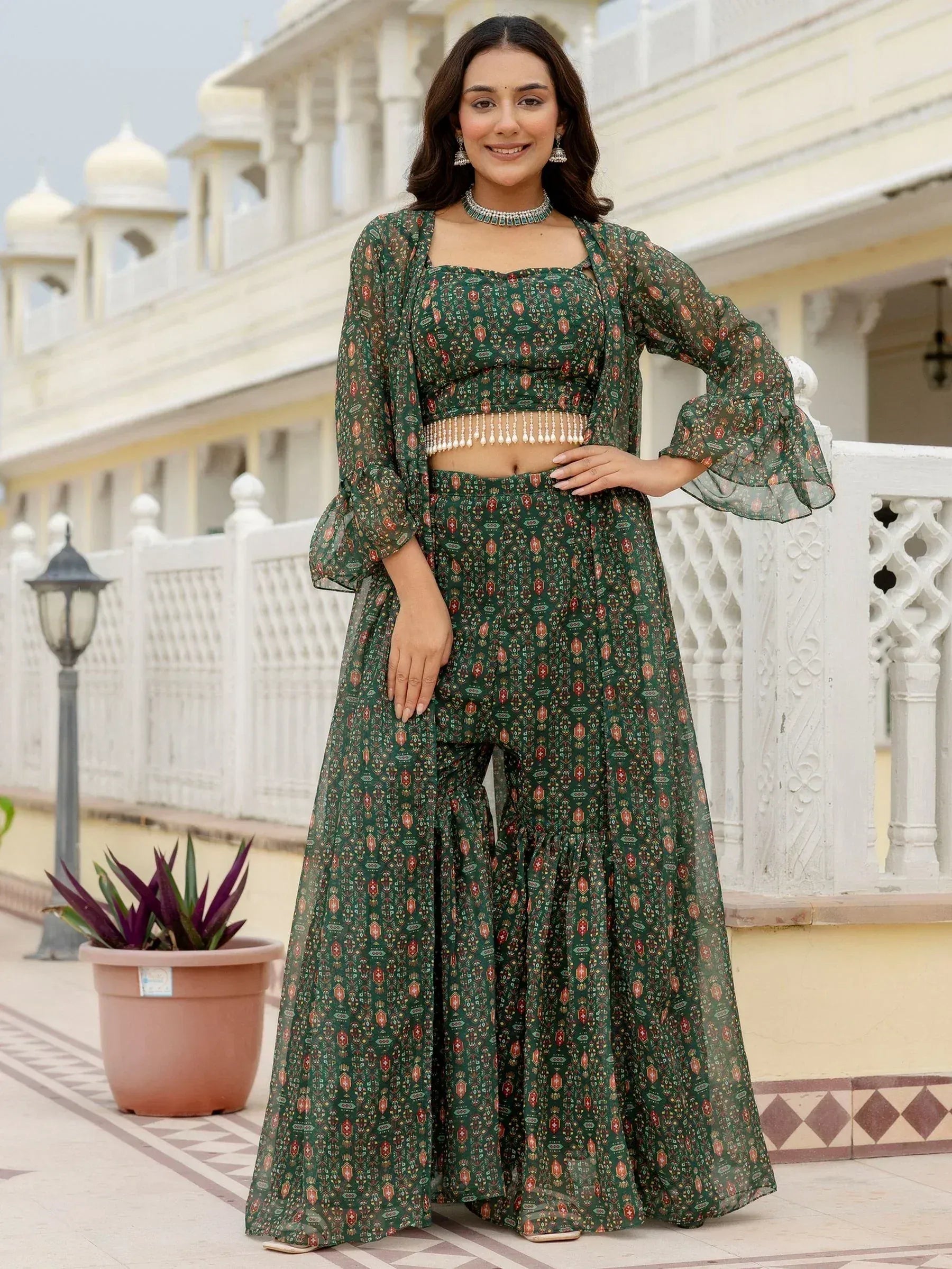 Green printed ethnic palazzo set with flared sleeves and pearl waistband, perfect for Indian occasions.
