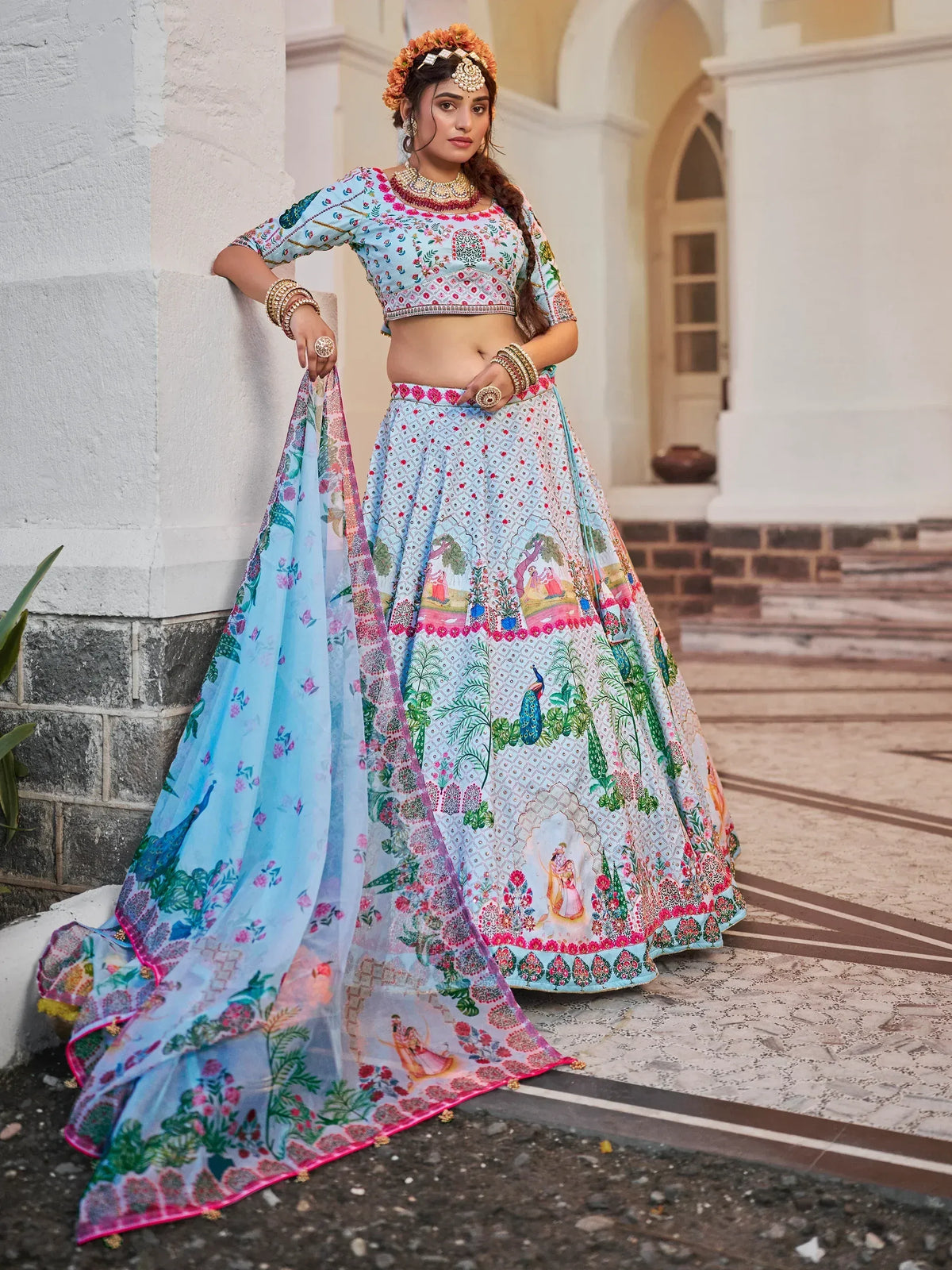 Woman in colorful printed lehenga choli with peacock and floral motifs, traditional Indian ethnic wear