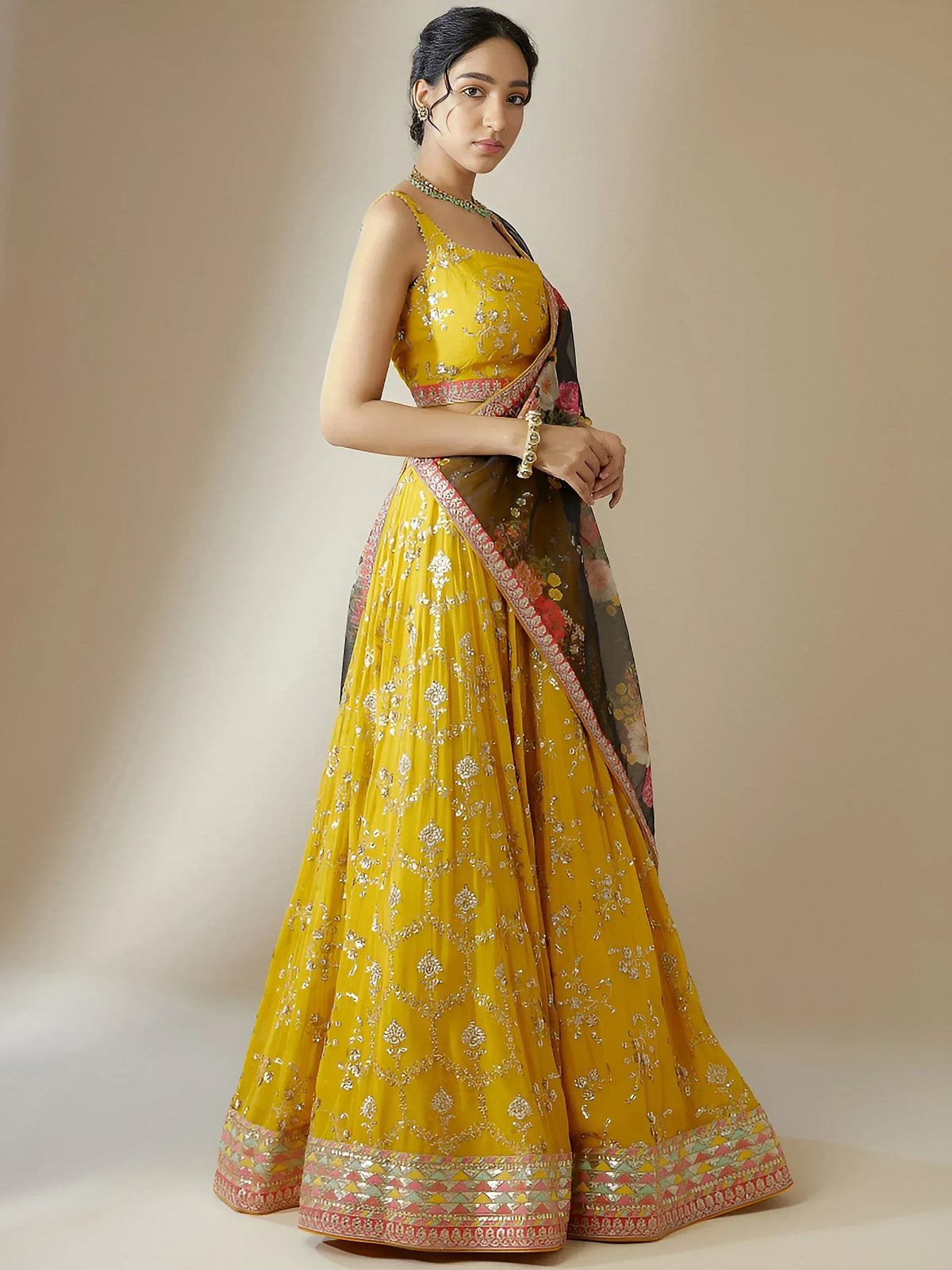 Yellow embroidered lehenga choli with floral dupatta, perfect for Indian ethnic occasions and weddings.