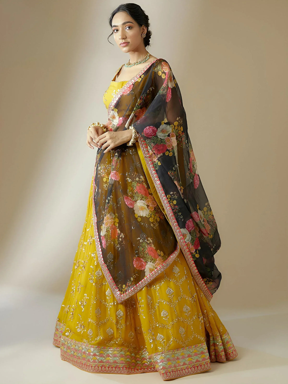 Yellow designer lehenga choli with floral dupatta, perfect for Indian weddings and festive occasions.