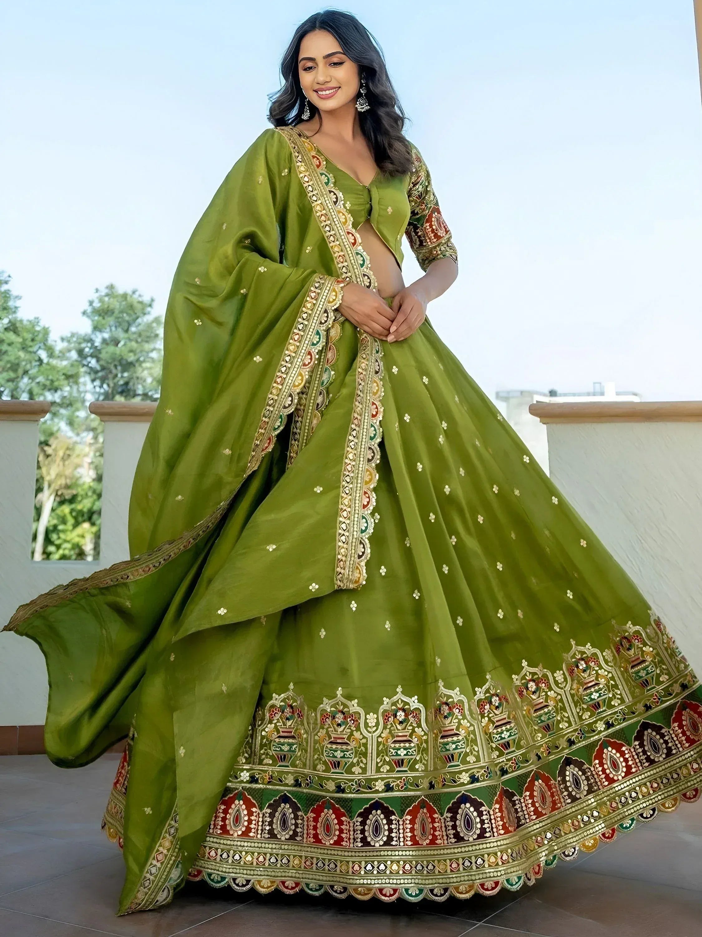 Elegant green lehenga choli with intricate embroidery and vibrant borders for festive occasions