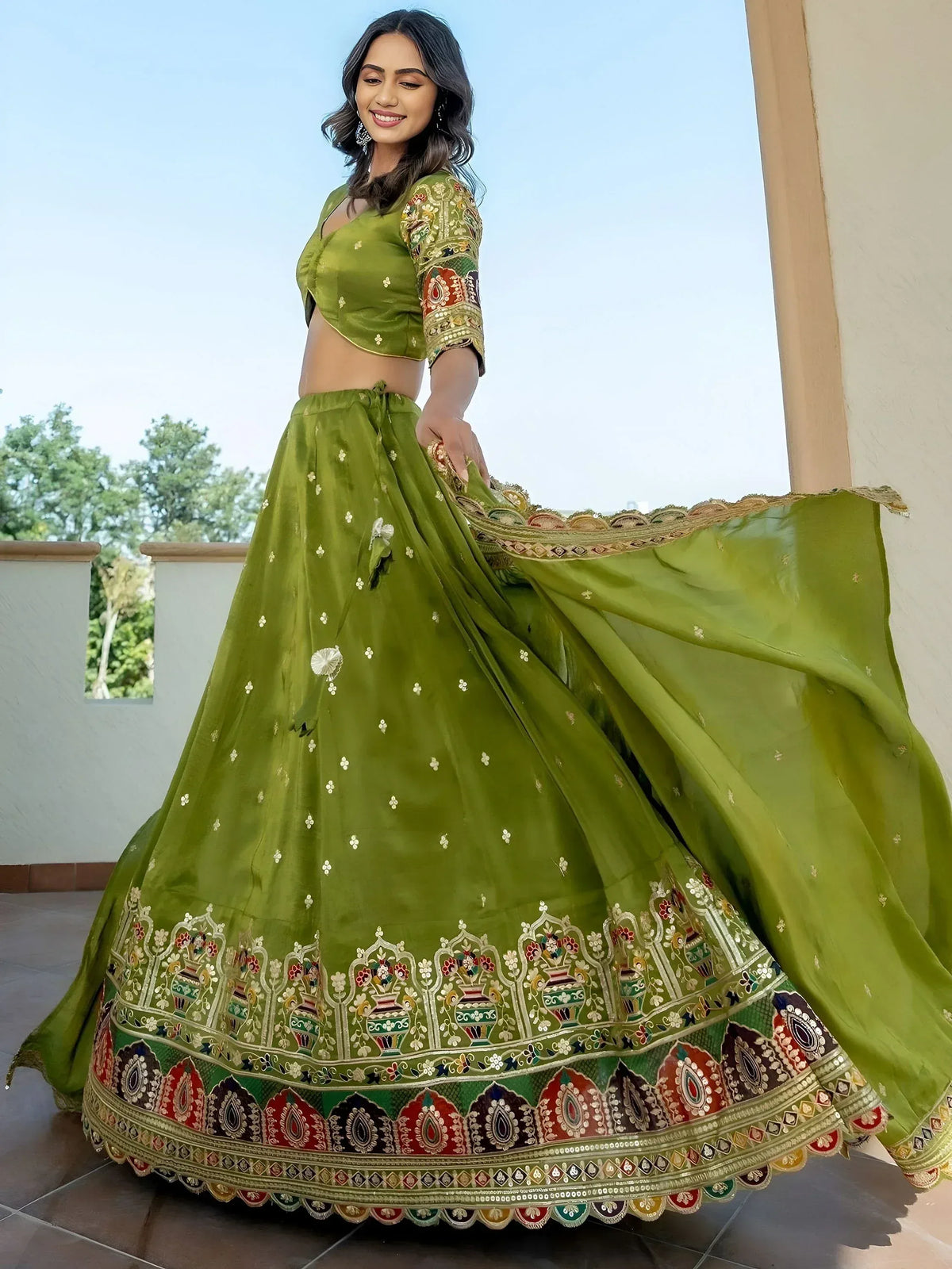 Green embroidered lehenga choli with floral and vase motifs, perfect for Indian ethnic wear