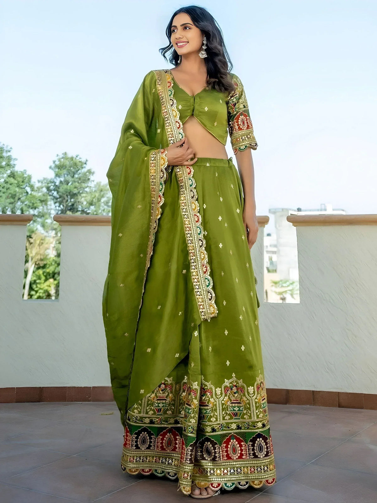 Green embroidered lehenga choli with intricate border designs, perfect for Indian ethnic wear.