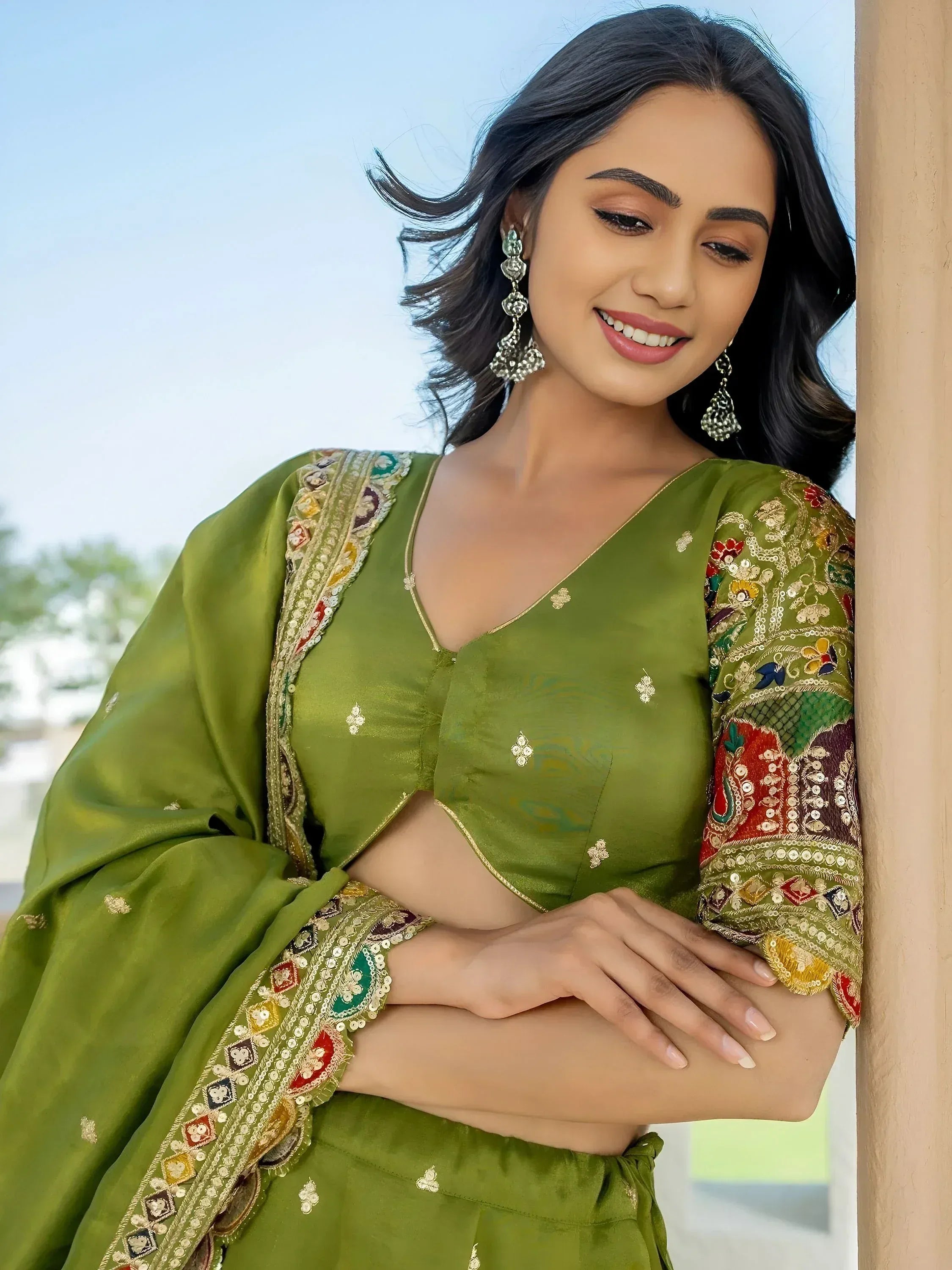 Green embroidered ethnic salwar kameez with floral detailing and statement earrings