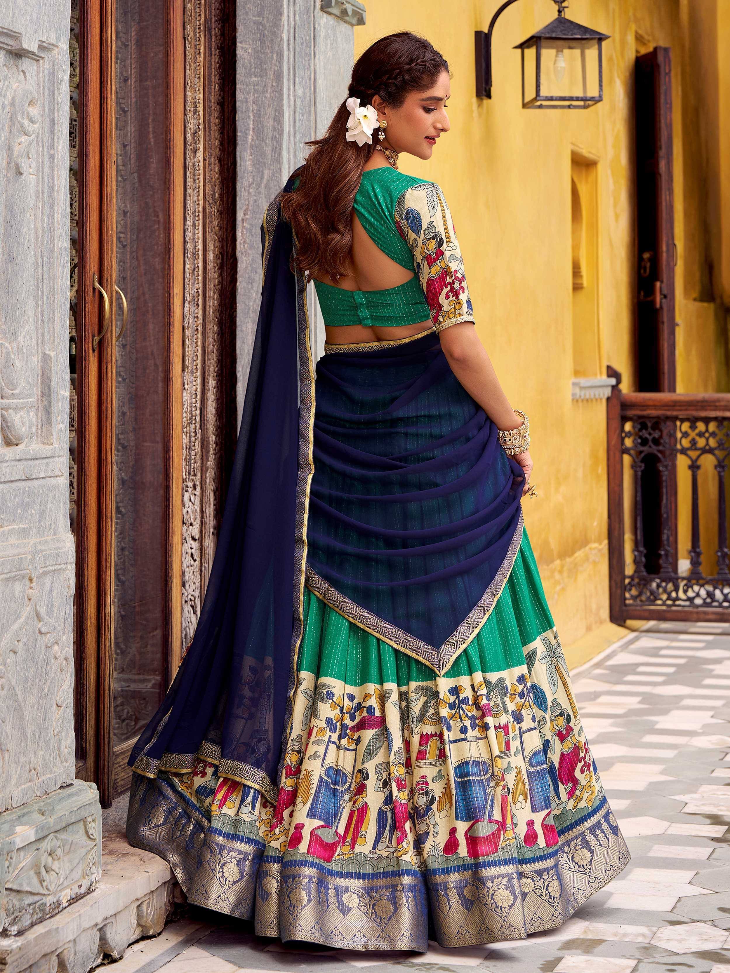 Woman in green and navy blue designer lehenga choli with printed motifs, perfect for Indian ethnic wear