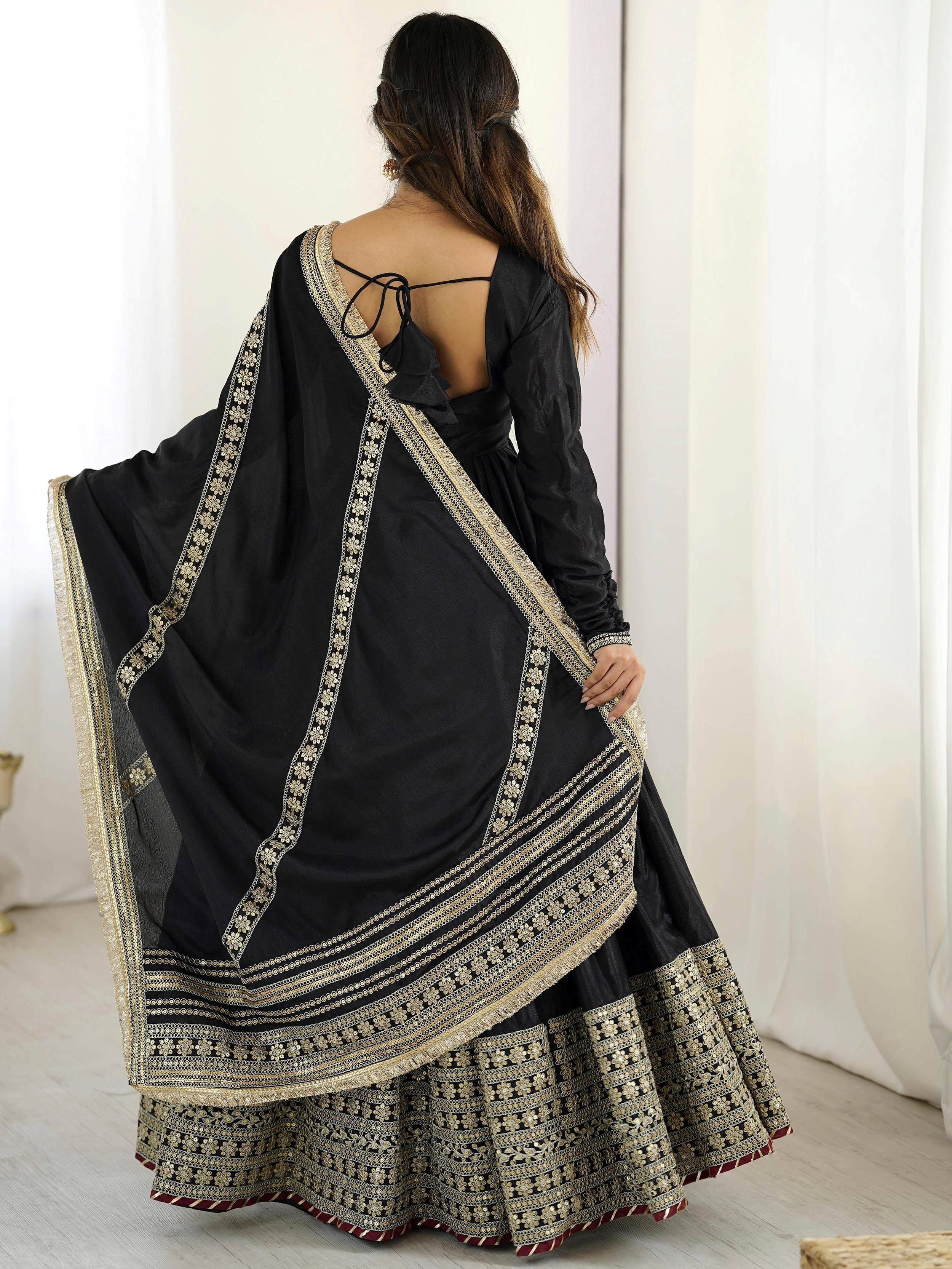 Black designer lehenga choli with gold embroidery and back tie detail, ethnic wear for women