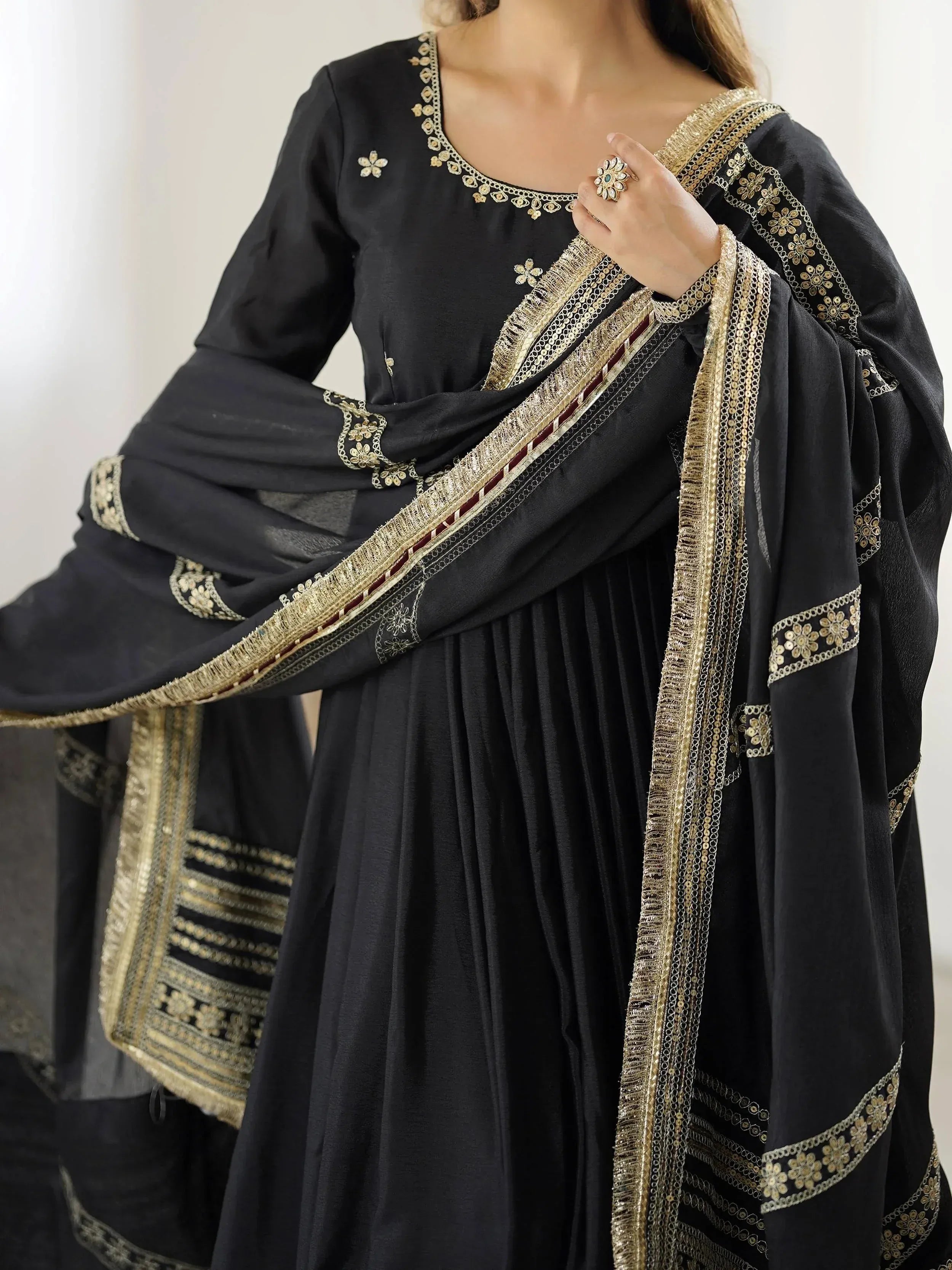Black ethnic salwar kameez with gold embroidery and sequin dupatta, perfect for Indian festive wear