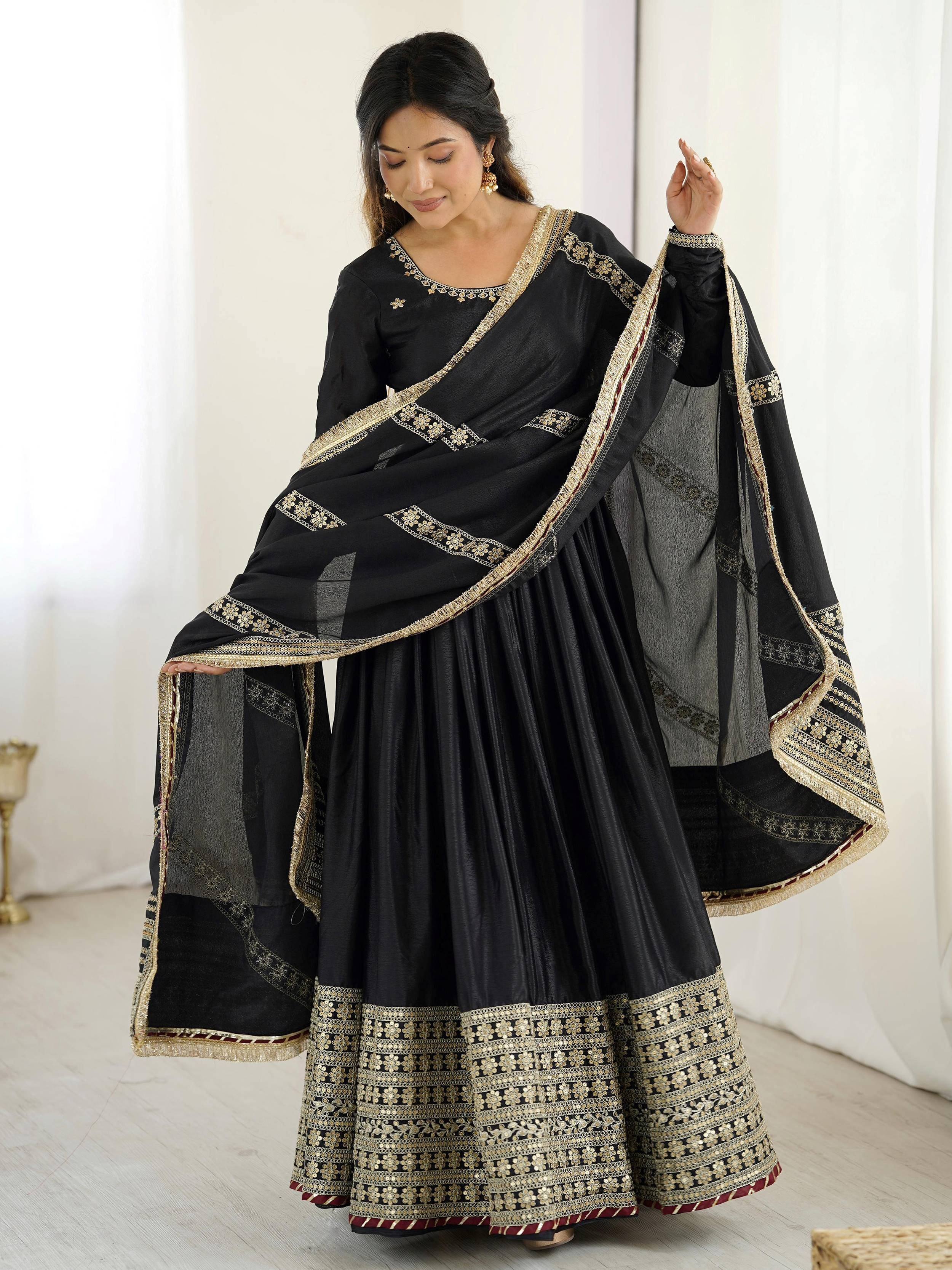 Black designer lehenga choli with gold embroidery and sheer dupatta, ethnic Indian wear