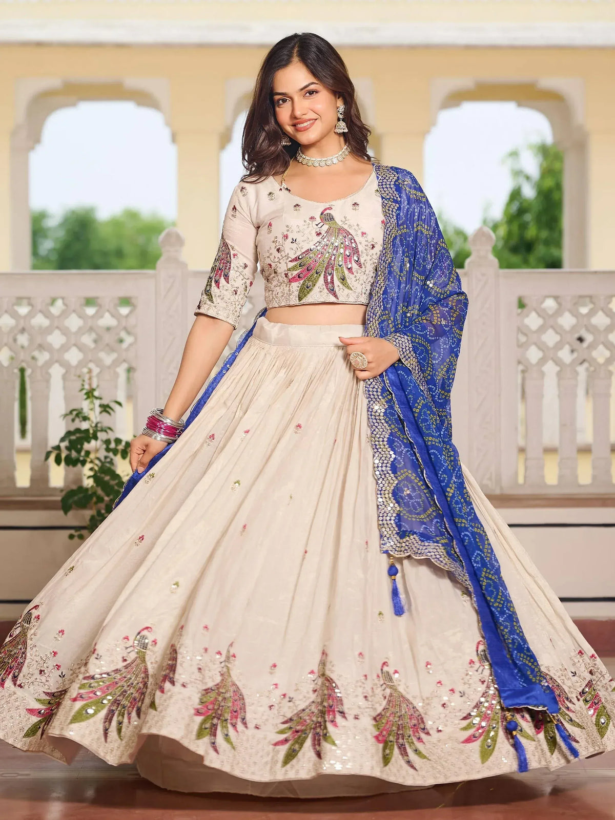 Cream peacock-embroidered lehenga choli with blue dupatta, Indian ethnic wear for women