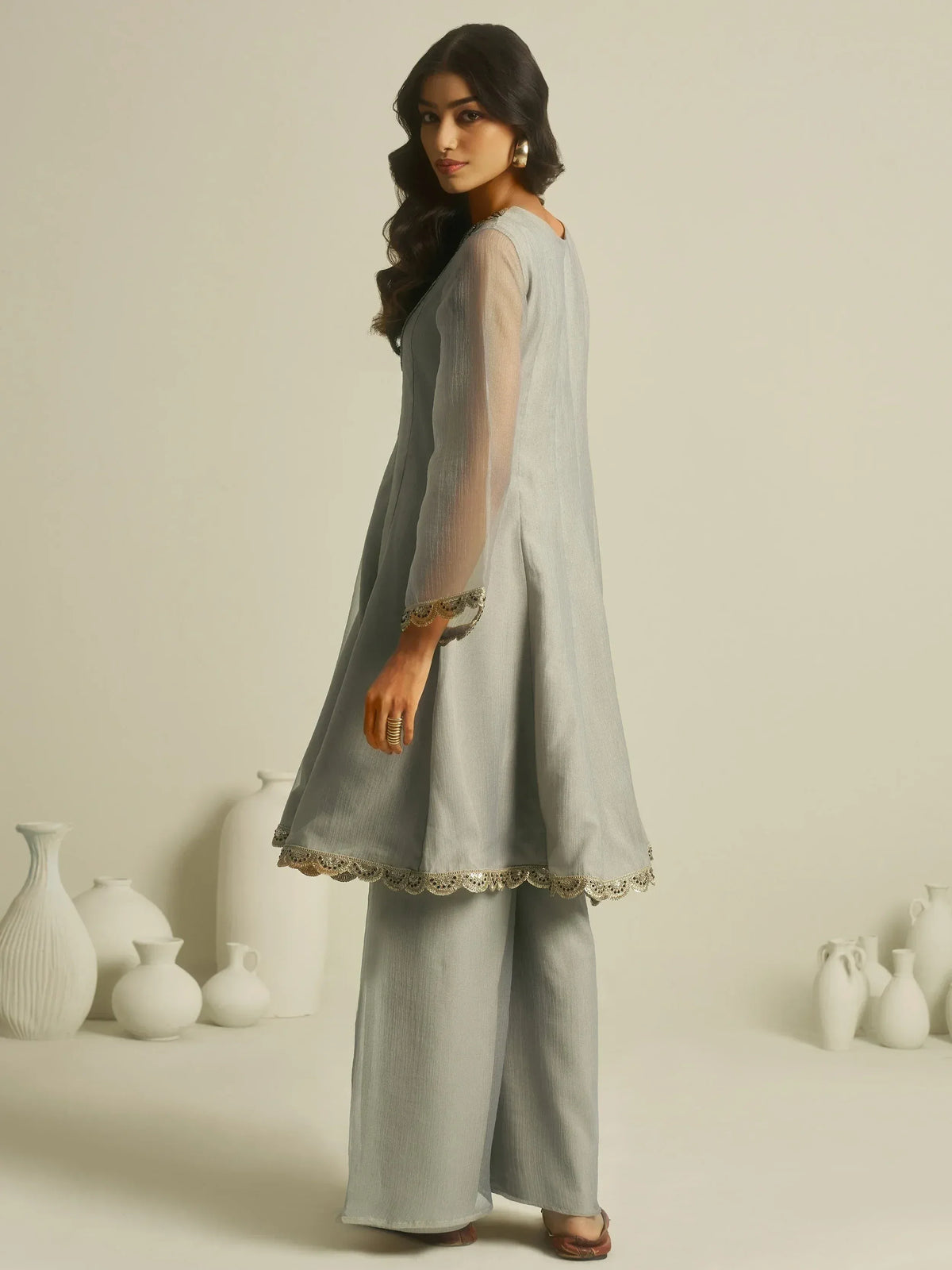 Grey ethnic kurta with gold lace detailing, paired with palazzo pants, ideal for Indian festive wear