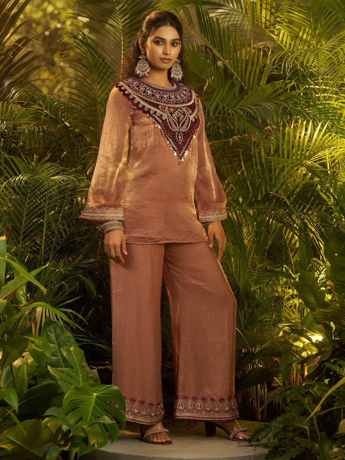 Elegant maroon and gold embroidered ethnic salwar kameez with wide pants, perfect for festive occasions.