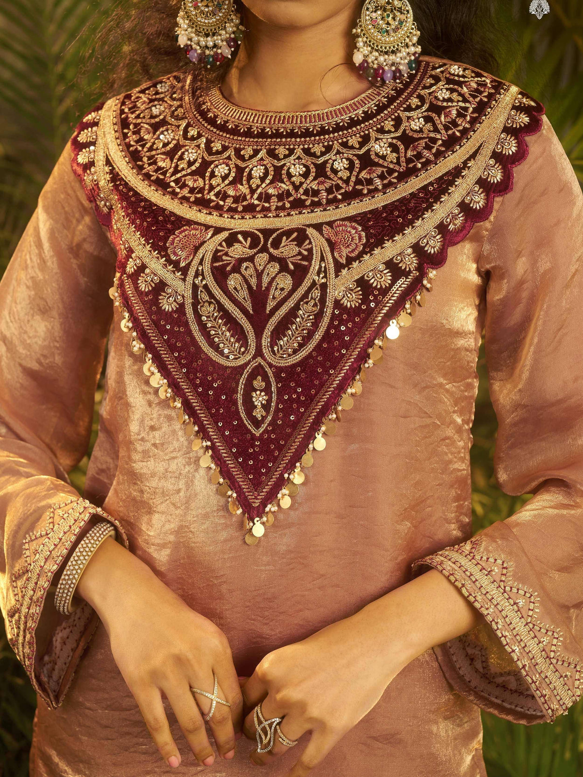 Elegant maroon and gold embroidered ethnic blouse with intricate paisley design and coin detailing