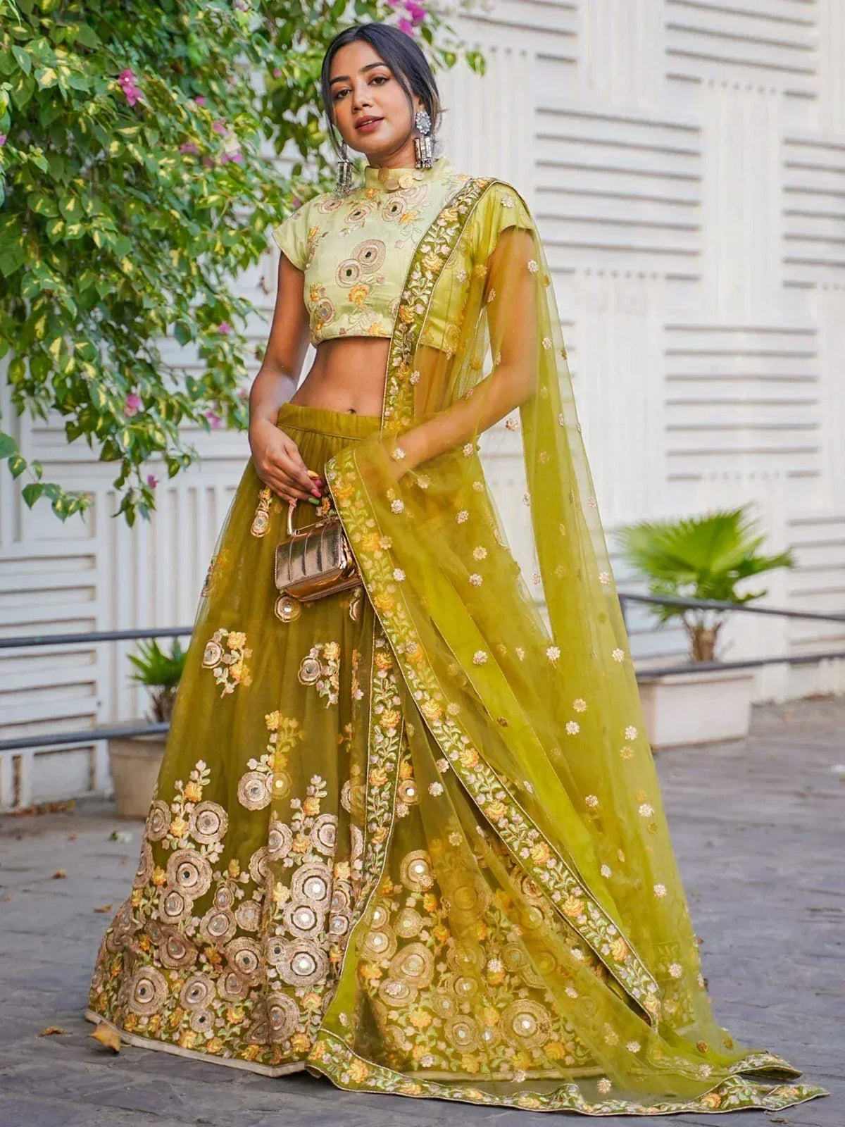 Elegant green embroidered lehenga choli with floral designs and sheer dupatta, perfect for Indian ethnic wear.