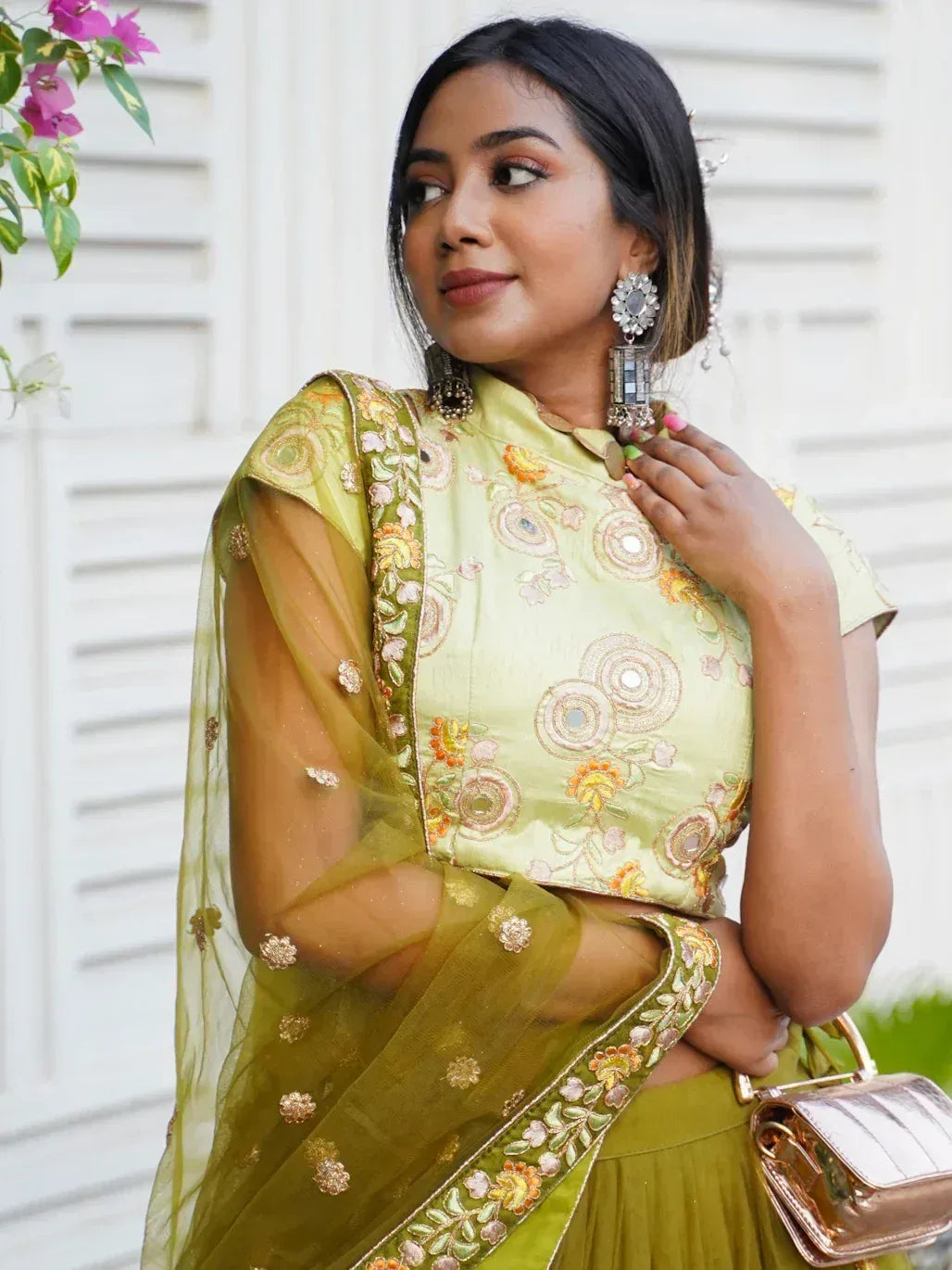 Elegant green embroidered lehenga choli with floral designs and sheer dupatta, perfect for Indian ethnic wear.