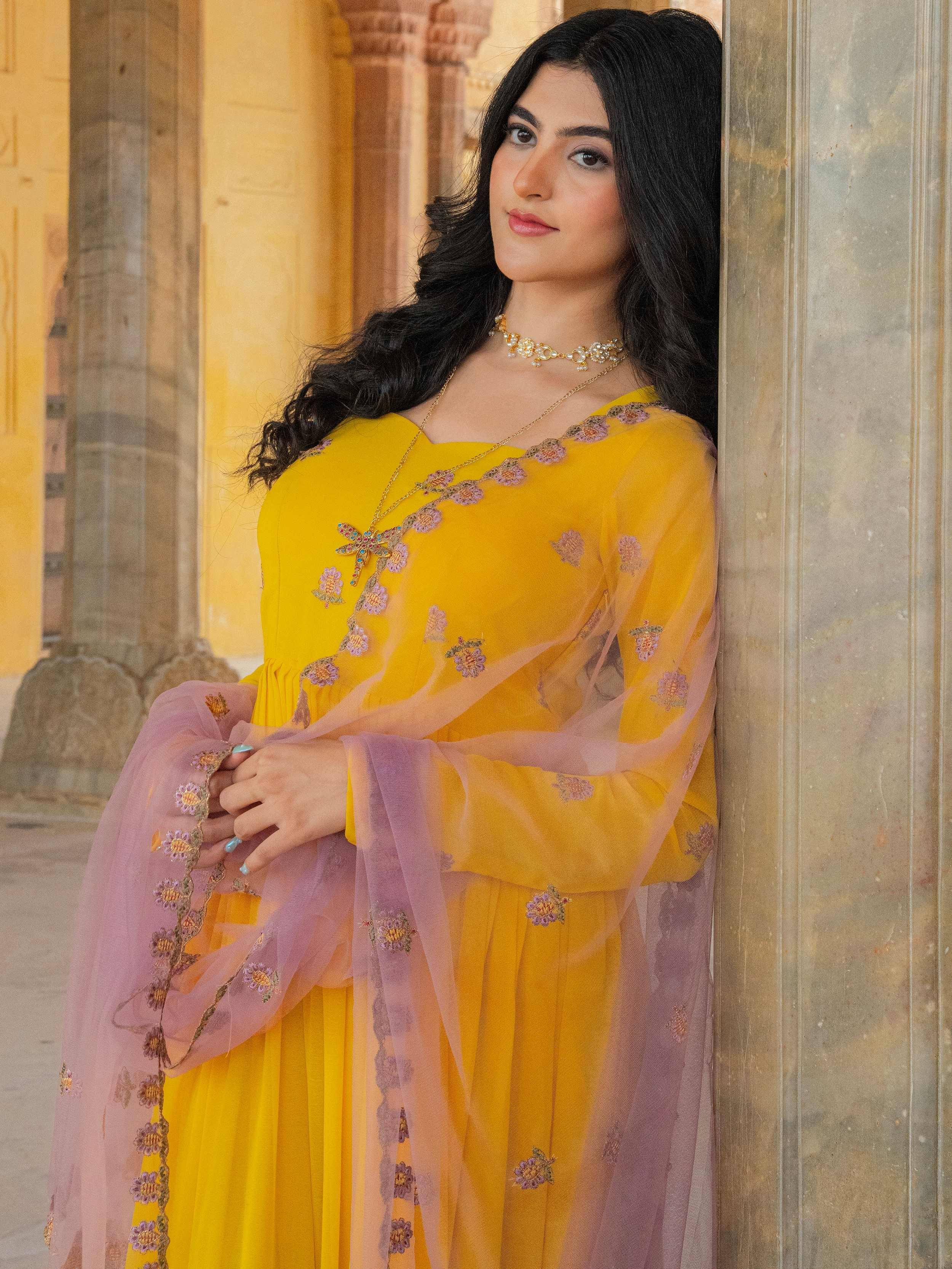 Yellow embroidered ethnic gown with sheer lavender sleeves, perfect for Indian celebrations and festive occasions.