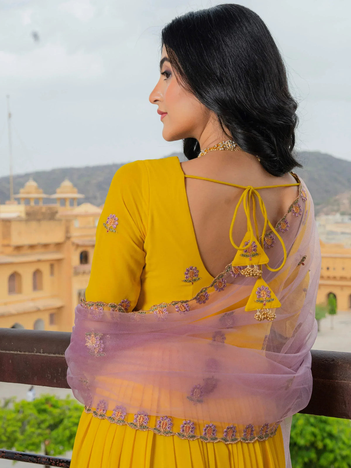 Yellow embroidered lehenga choli with sheer dupatta, floral motifs, and back tie detail