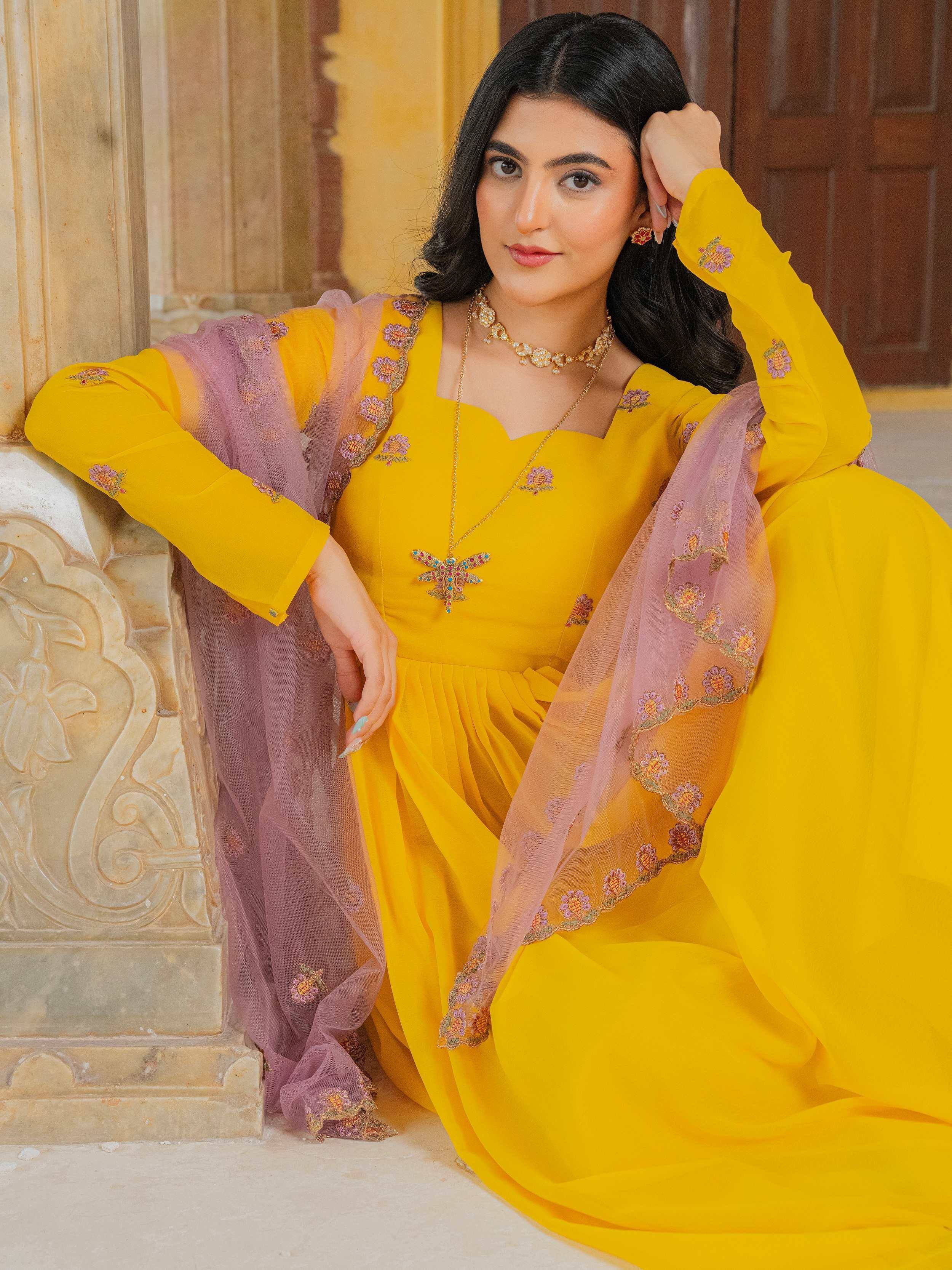 Yellow embroidered ethnic gown with purple dupatta, perfect for Indian occasions and festive wear.
