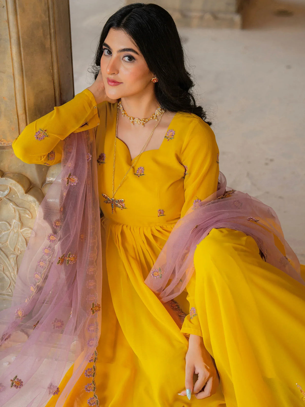 Yellow embroidered ethnic gown with purple dupatta, perfect for Indian festive occasions and weddings.