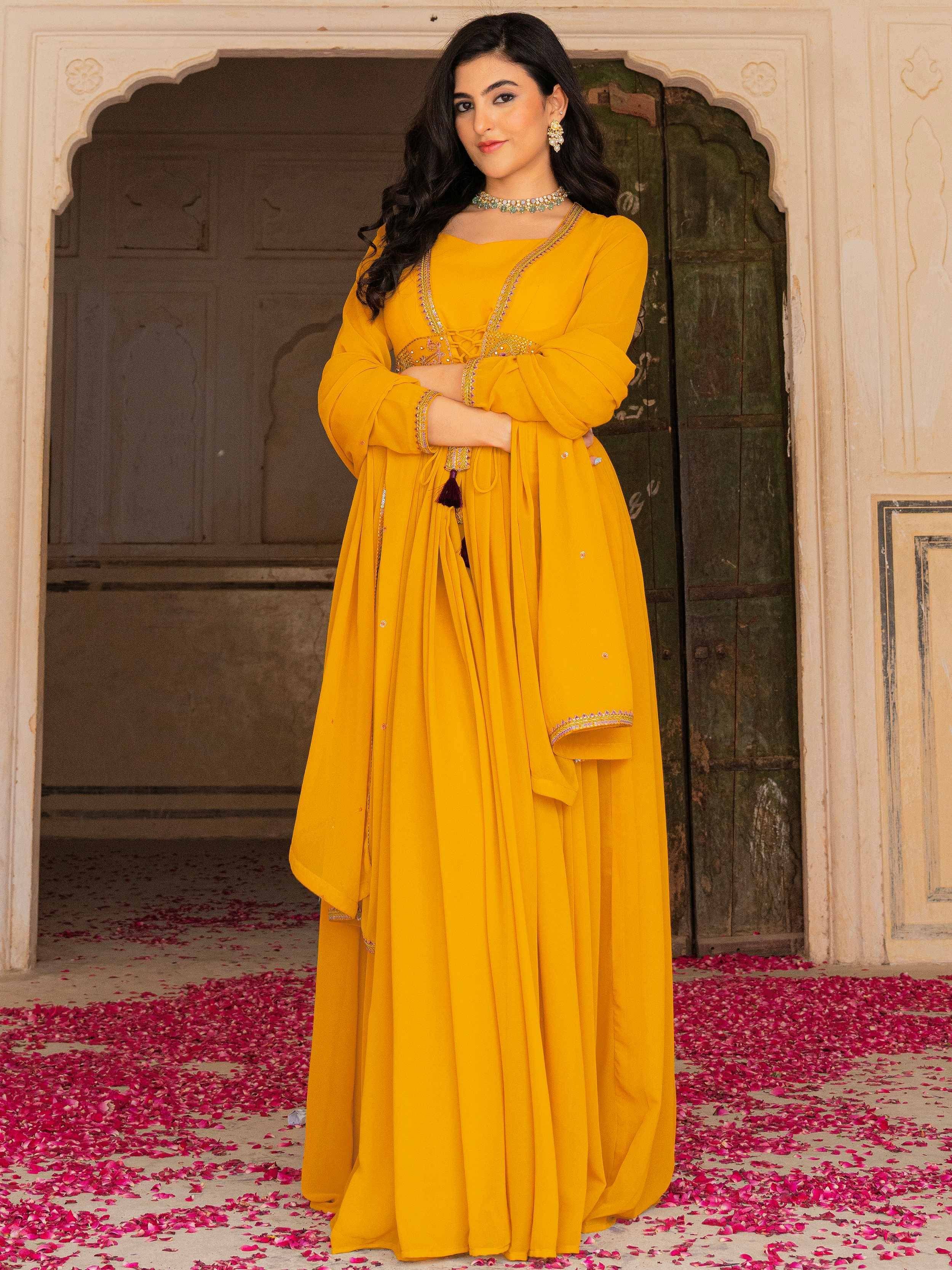 Yellow ethnic gown with gold embroidery, perfect for Indian weddings and festive occasions.