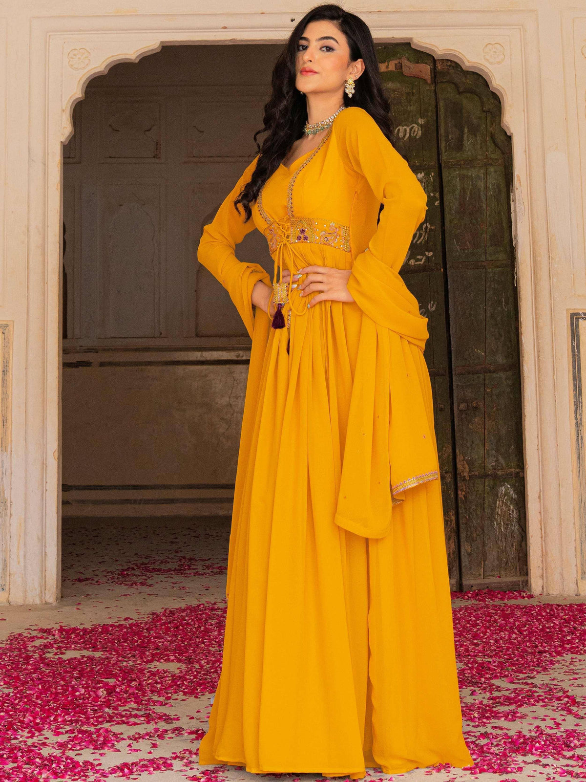 Vibrant yellow ethnic gown with embroidered waistband, perfect for Indian celebrations and festive occasions.