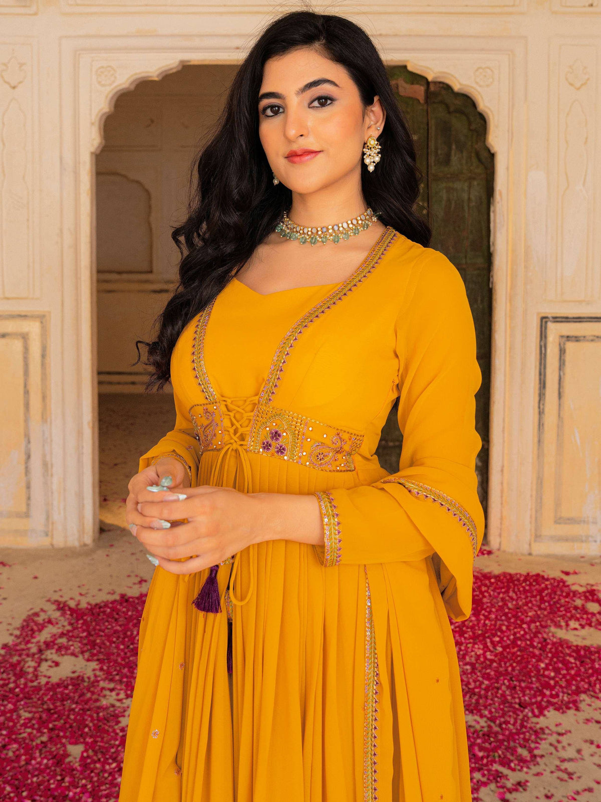 Yellow embroidered ethnic gown with lace-up waist, perfect for Indian occasions and festive wear.