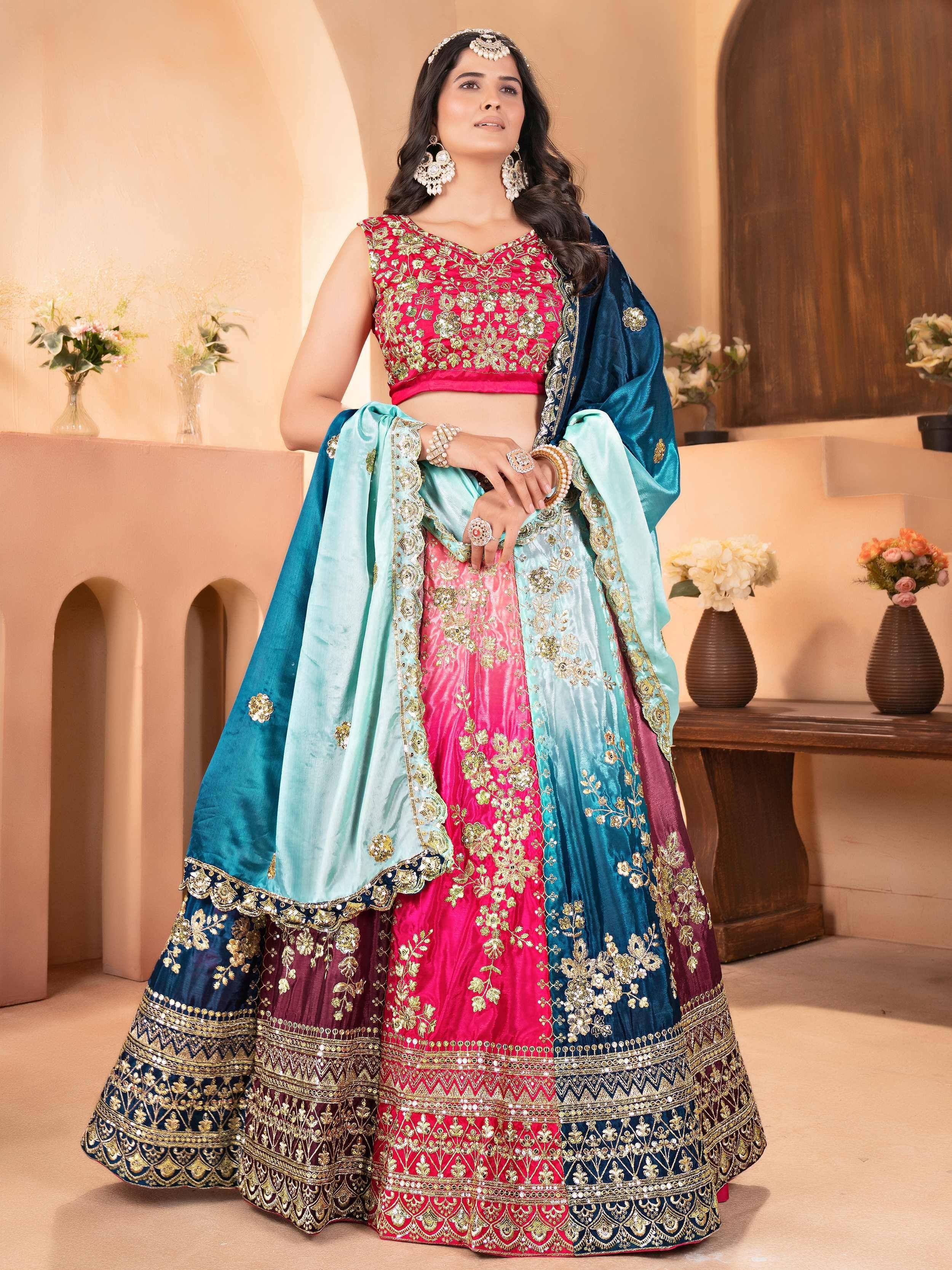 Designer lehenga choli with pink and blue velvet, gold embroidery, perfect for Indian weddings and festive occasions.