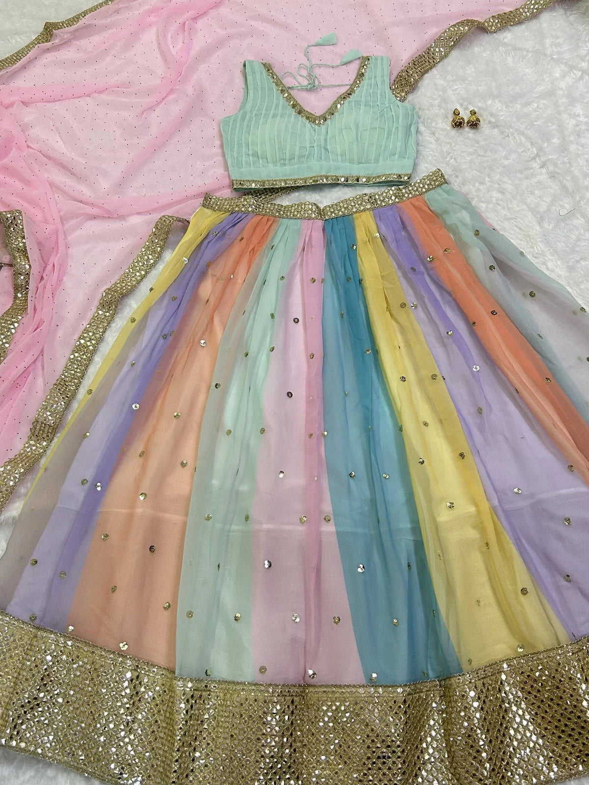 Rainbow-colored ethnic lehenga choli with gold embellishments and matching dupatta