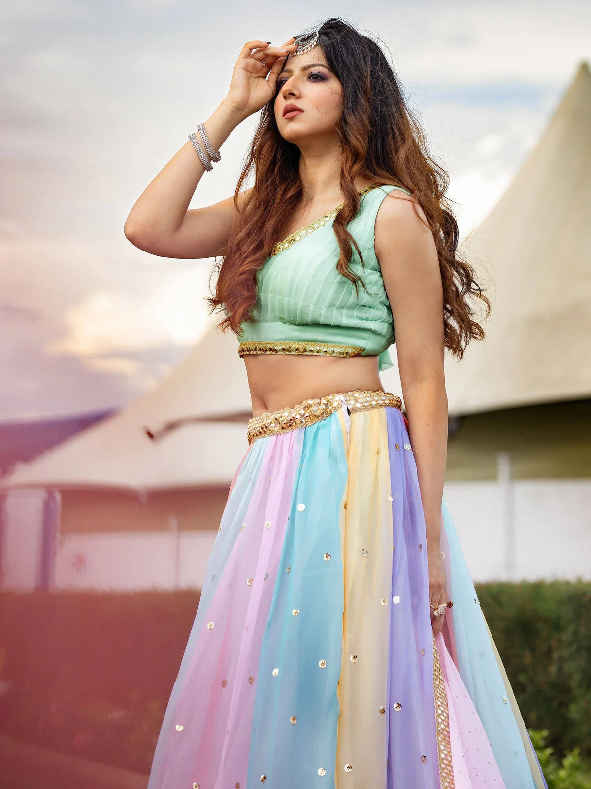 Pastel rainbow lehenga choli with gold embroidery and embellished waistband for festive occasions