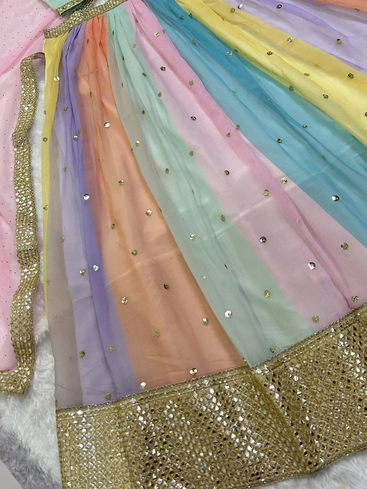 Rainbow-colored ethnic lehenga with gold sequin detailing and pastel stripes