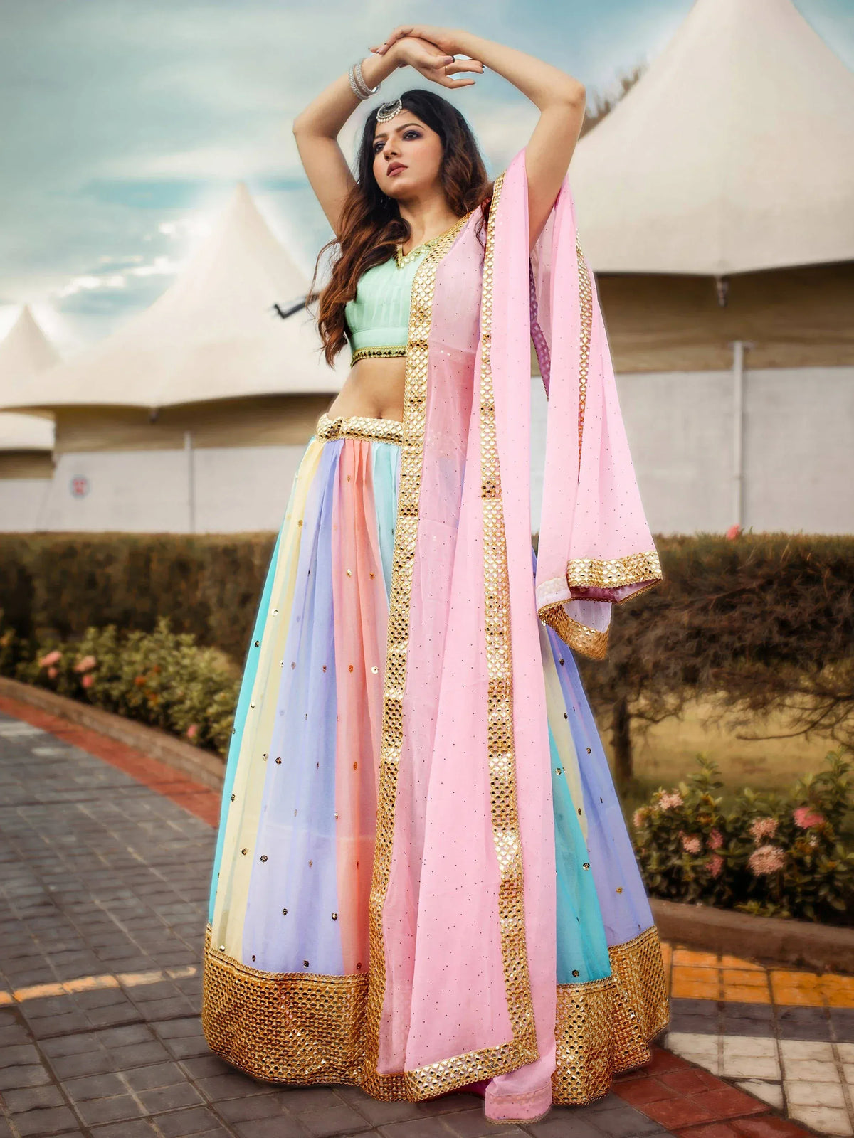 Pastel rainbow lehenga choli with gold embroidery, perfect for Indian ethnic wear events