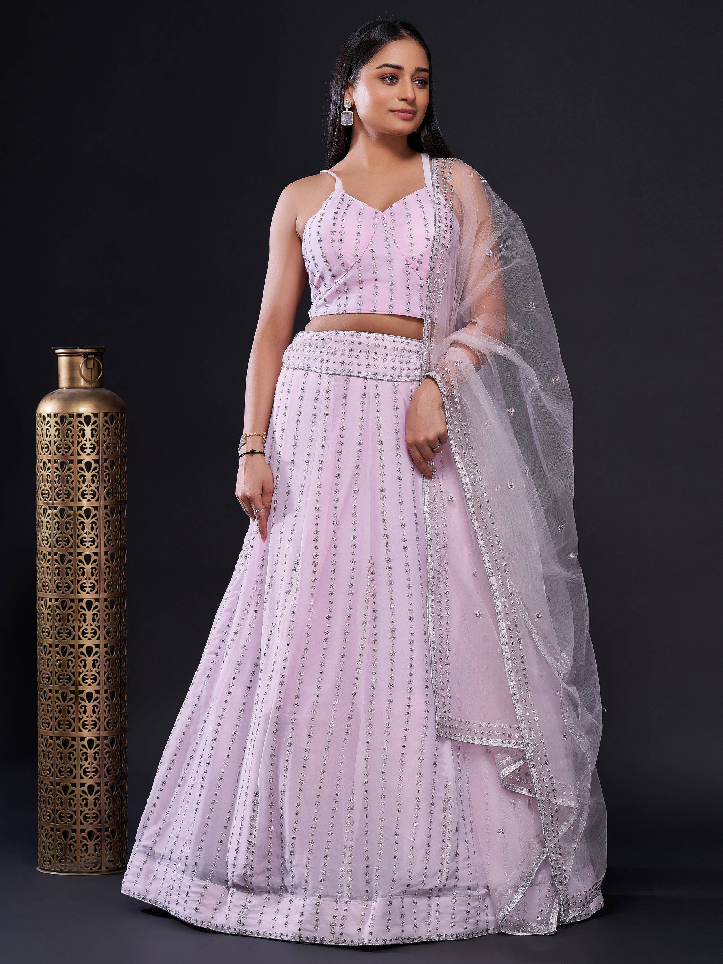 Elegant pink lehenga choli with intricate embroidery and sheer dupatta for festive occasions
