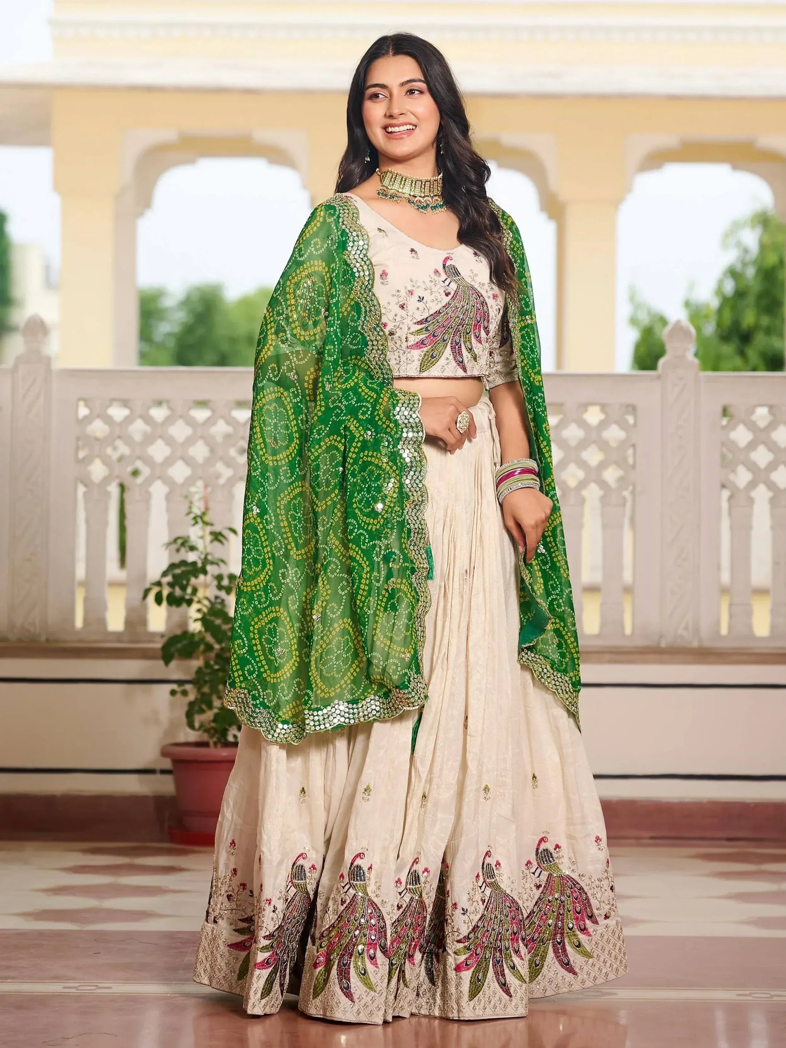 Cream peacock-embroidered lehenga choli with green dupatta, Indian ethnic wear for weddings and festivals