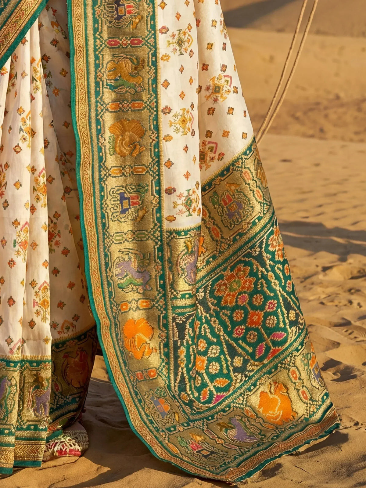 Elegant Indian ethnic saree with intricate gold and green embroidery, floral motifs, and traditional border designs.