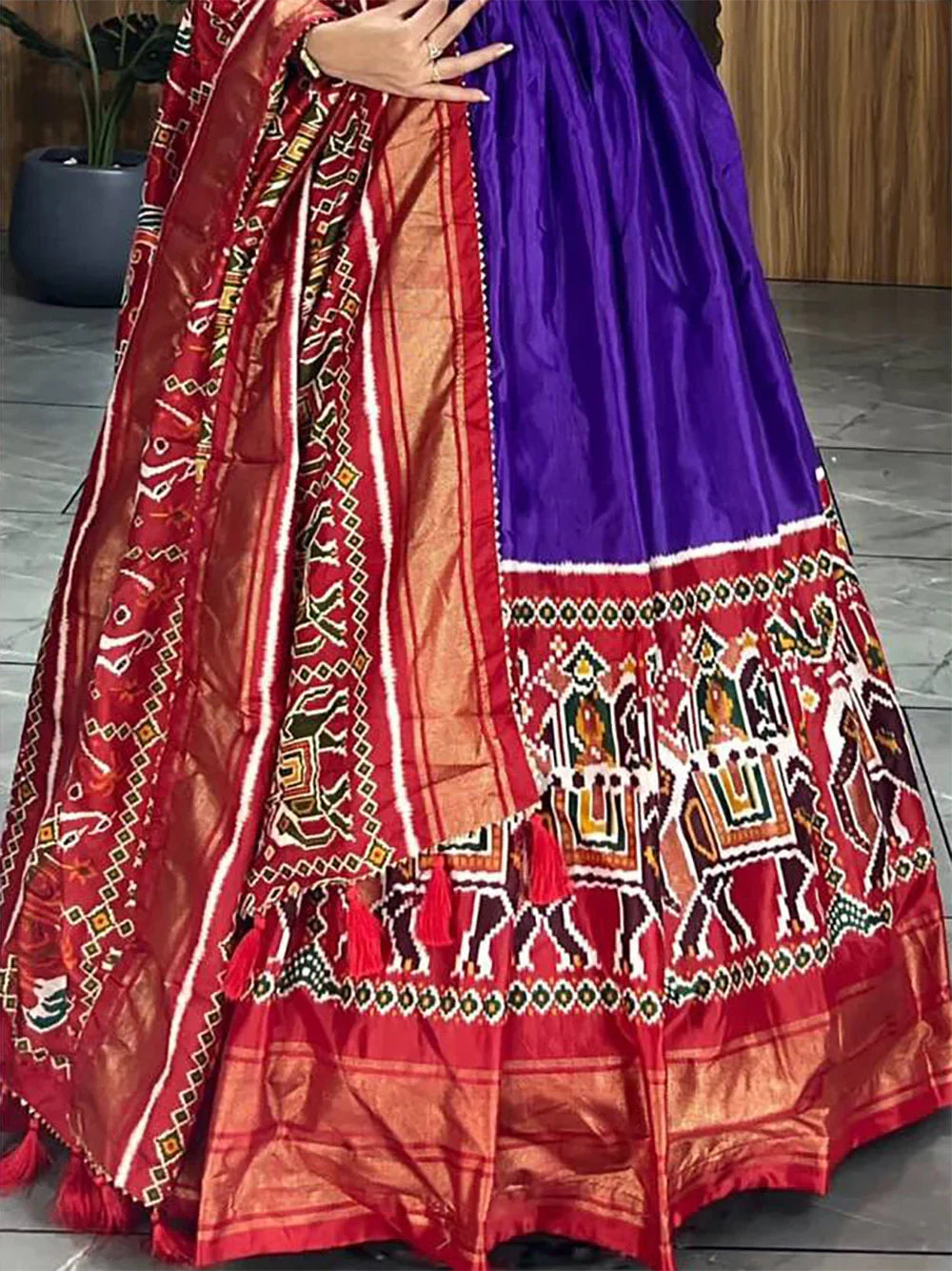 Purple ethnic lehenga with red dupatta, featuring traditional Indian embroidery and mirror work