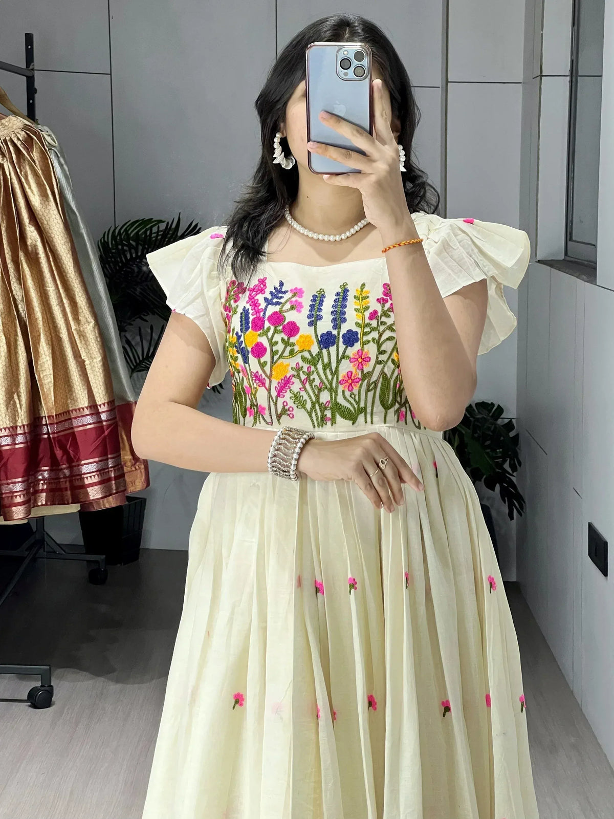 Cream floral embroidered ethnic gown with puff sleeves, perfect for Indian occasions and festive wear.