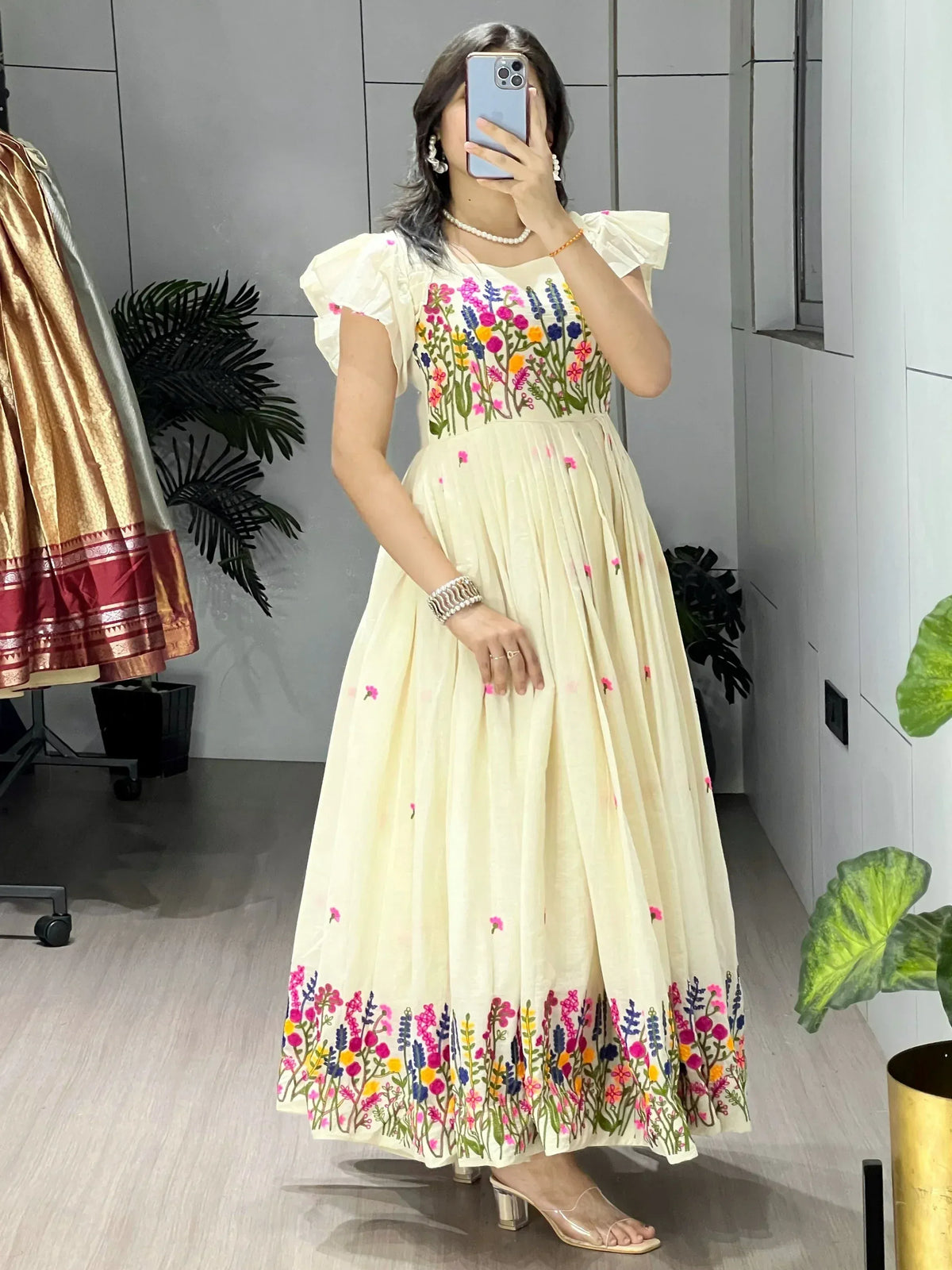Cream floral embroidered ethnic gown with puff sleeves, perfect for Indian occasions and festive wear.