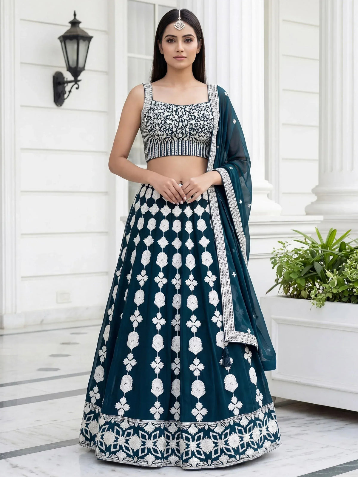 Teal lehenga choli with white floral embroidery, perfect for Indian weddings and festive occasions