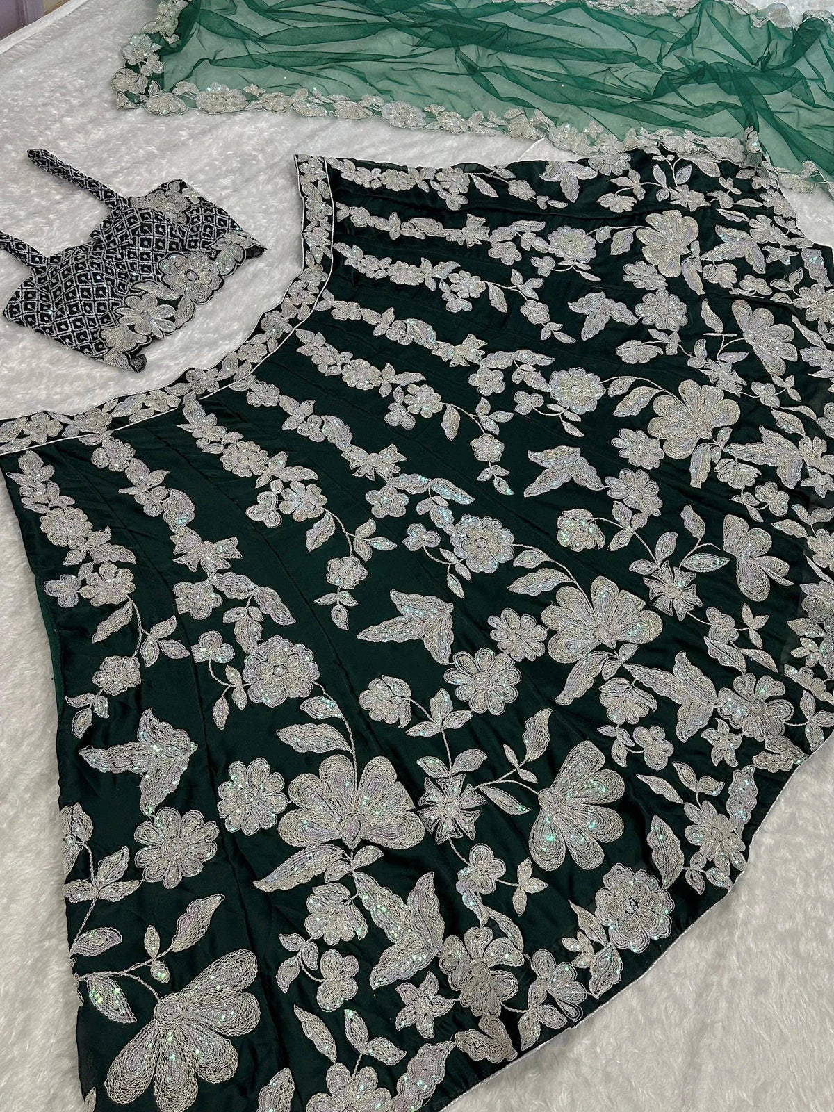 Dark green designer lehenga choli with silver floral embroidery and matching dupatta
