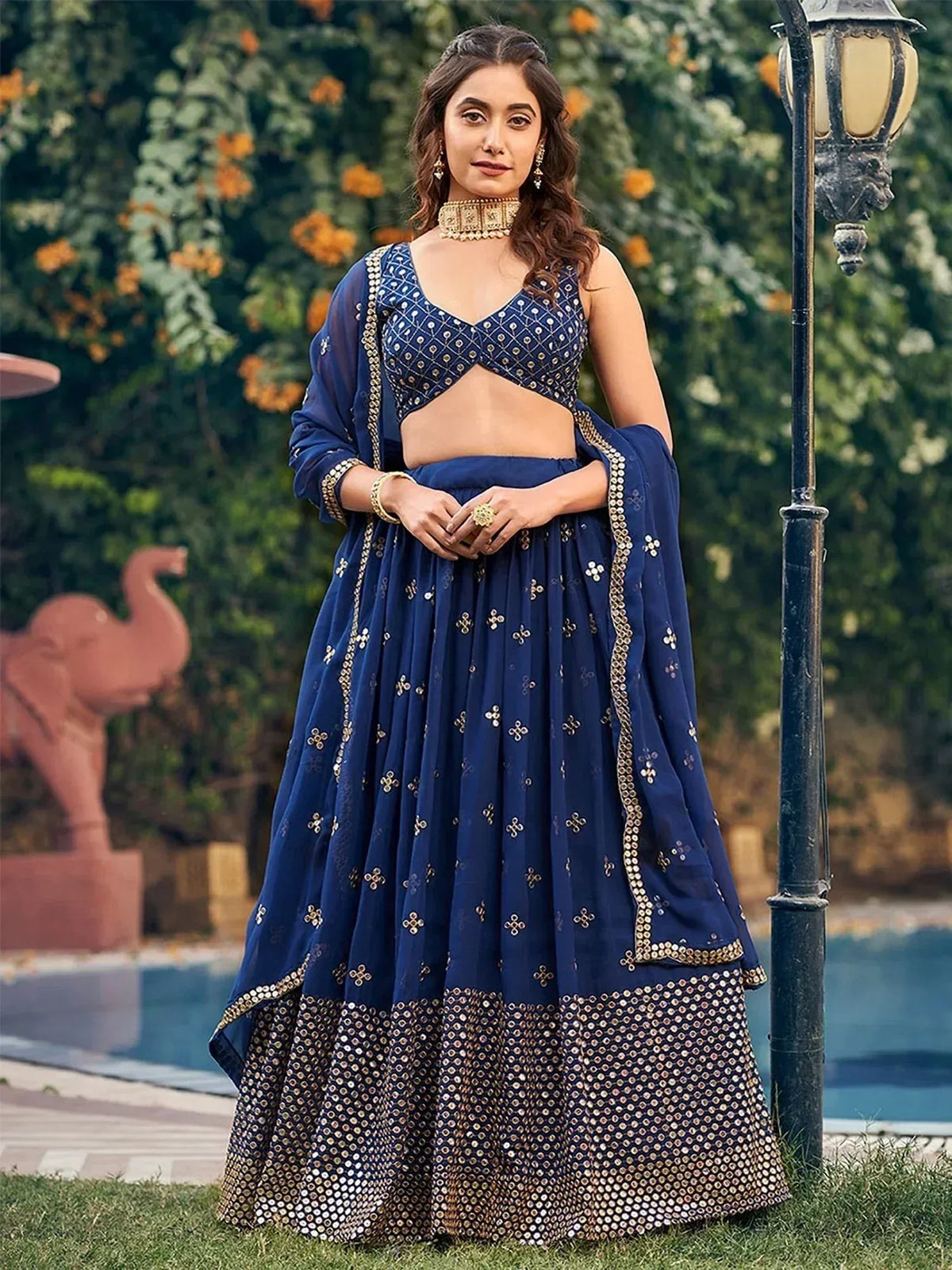 Navy blue designer lehenga choli with gold embroidery and mirror work, perfect for Indian ethnic occasions